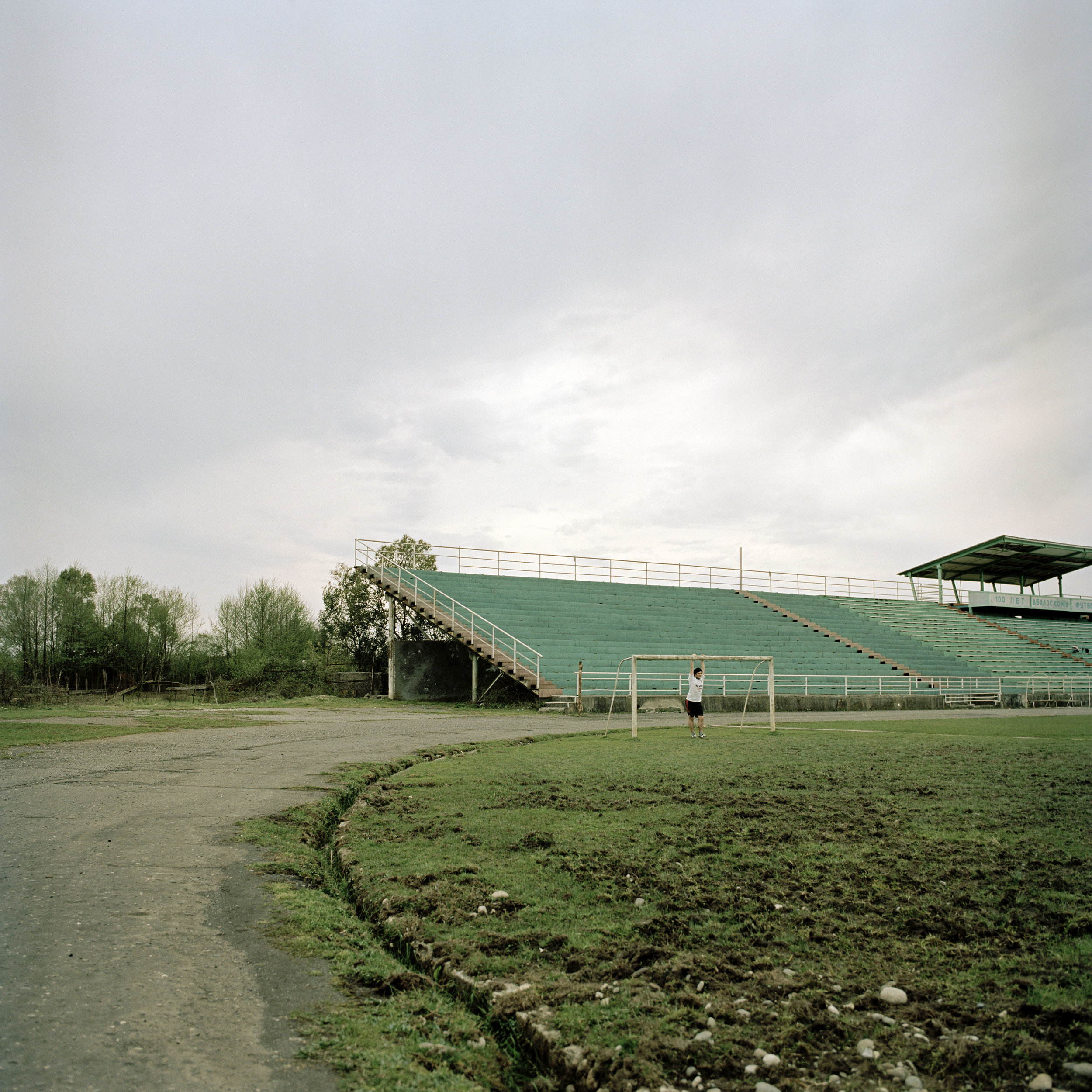 Georgian teenagers play football at the dilapidated stadium in the centre of Gali town.