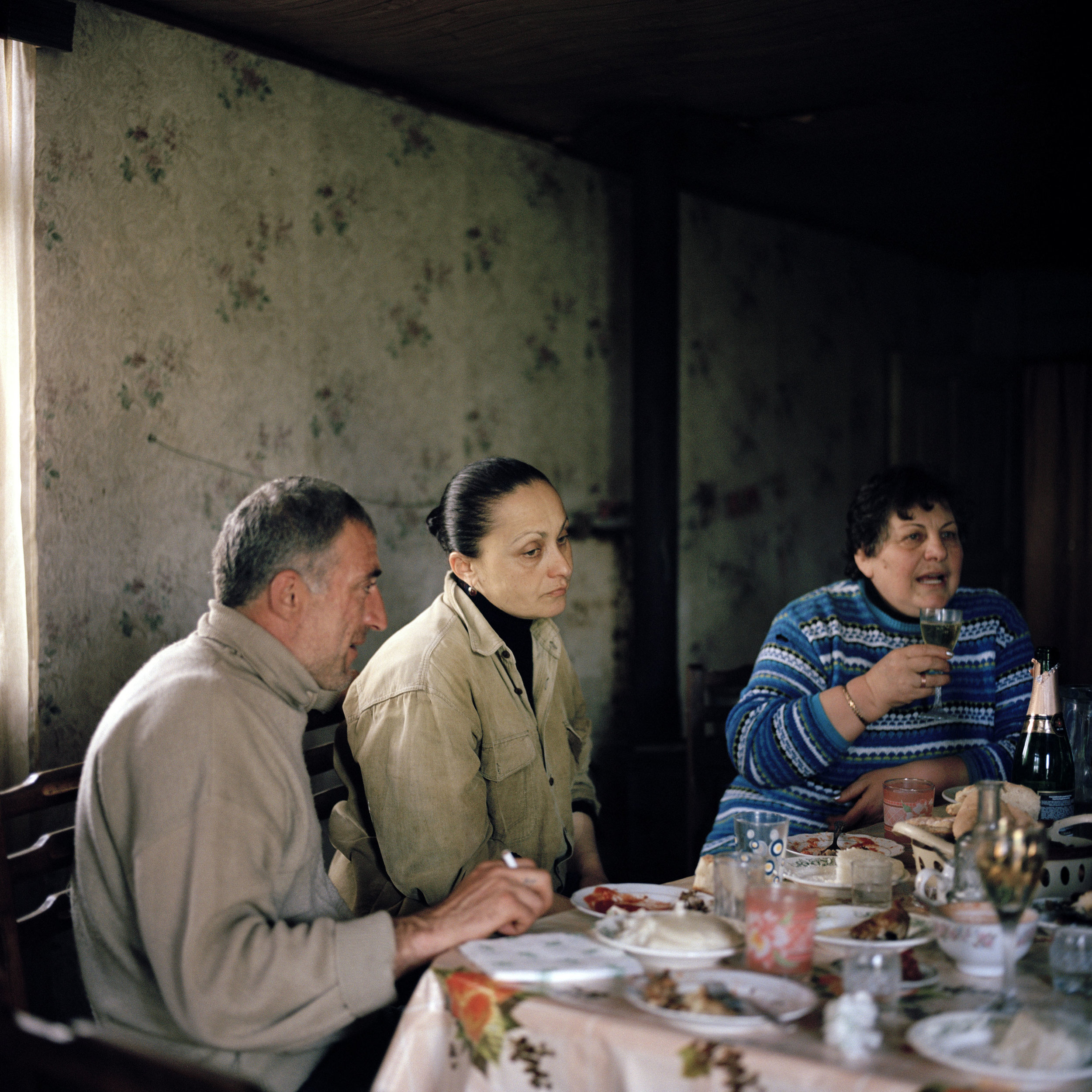 Friends and neighbors celebrate Niko Djologua’s (left) 40th birthday at his families’ house in the village of Tagiloni in lower Gali, Abkhazia's border region with Georgia proper.