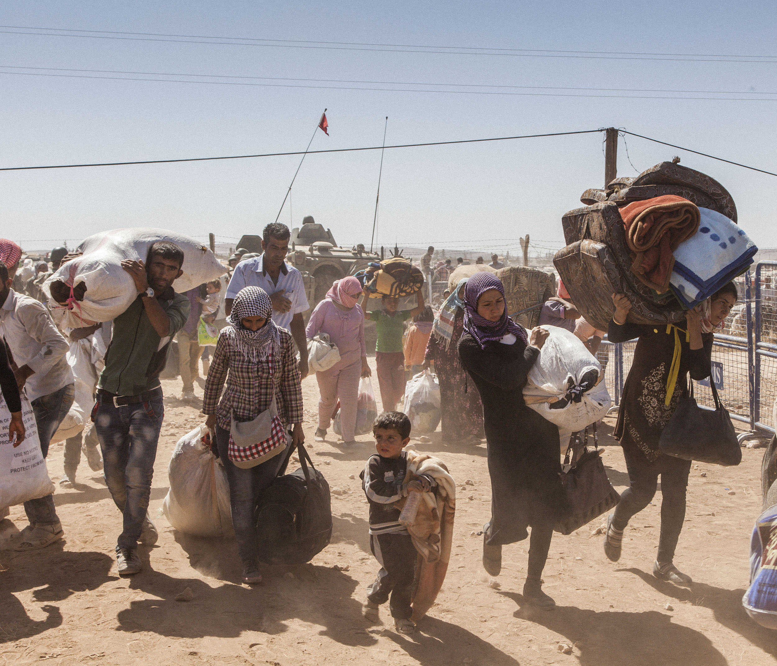  Syrian refugees cross the border from Syria into Turkey after fleeing fighting between Kurdish forces and ISIS around the city of Kobane in North East Syria. 