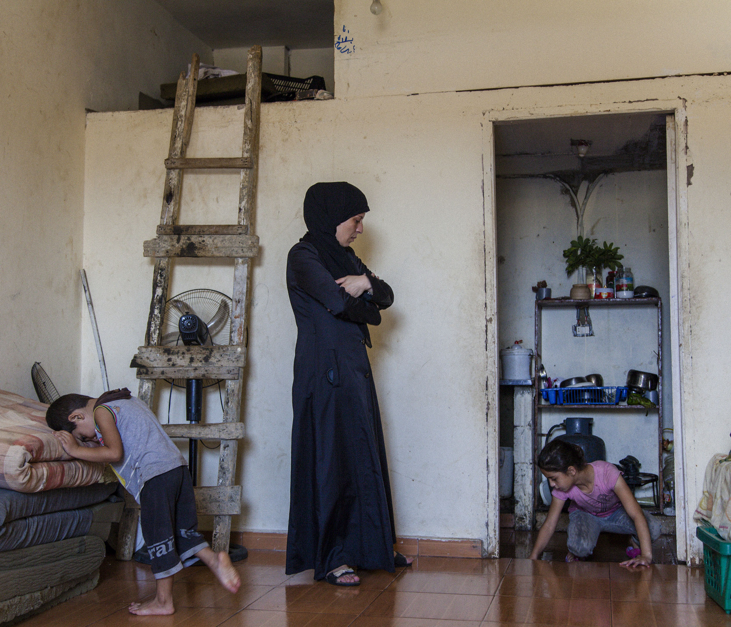  Single mother Iman in the one-roomed shop front where she lives as a refugee with her three children in Tripoli, Lebanon. 