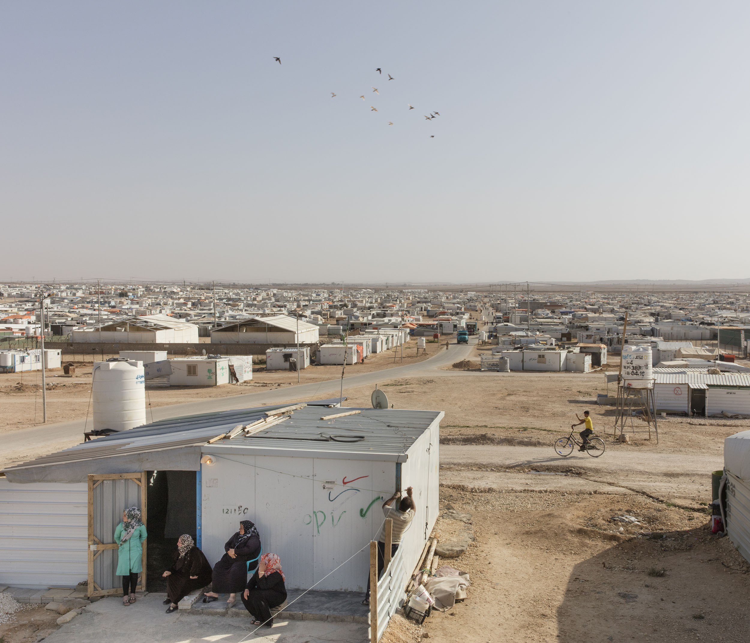  Syrian refugees move through Zaatari refugee camp, home to more than 80,000 refugees. 