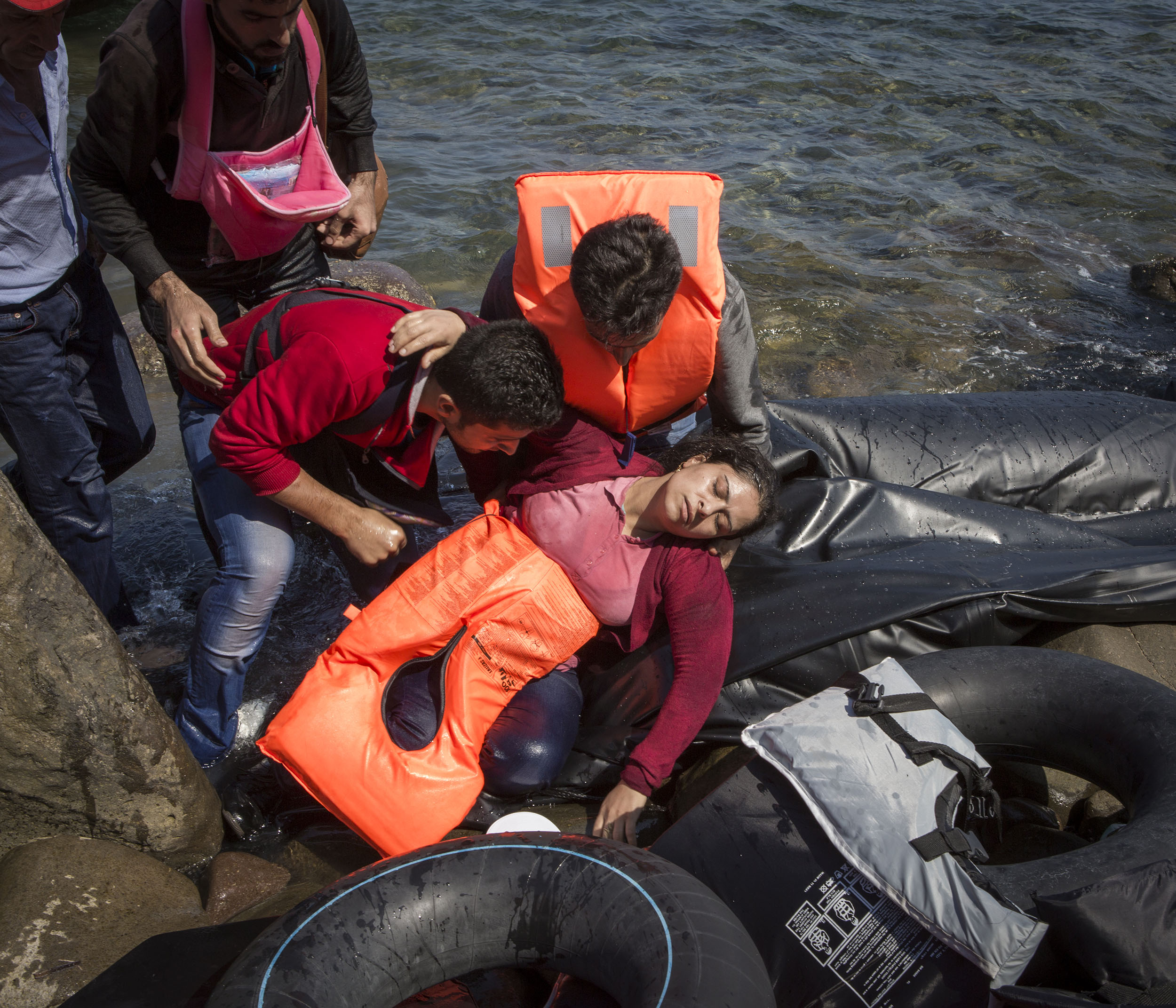 35-year-old Syrian refugee Susan from Aleppo collapses from sea-sickness and fatigue after crossing the Aegean from Turkey to Lesbos with her husband and 3 children.