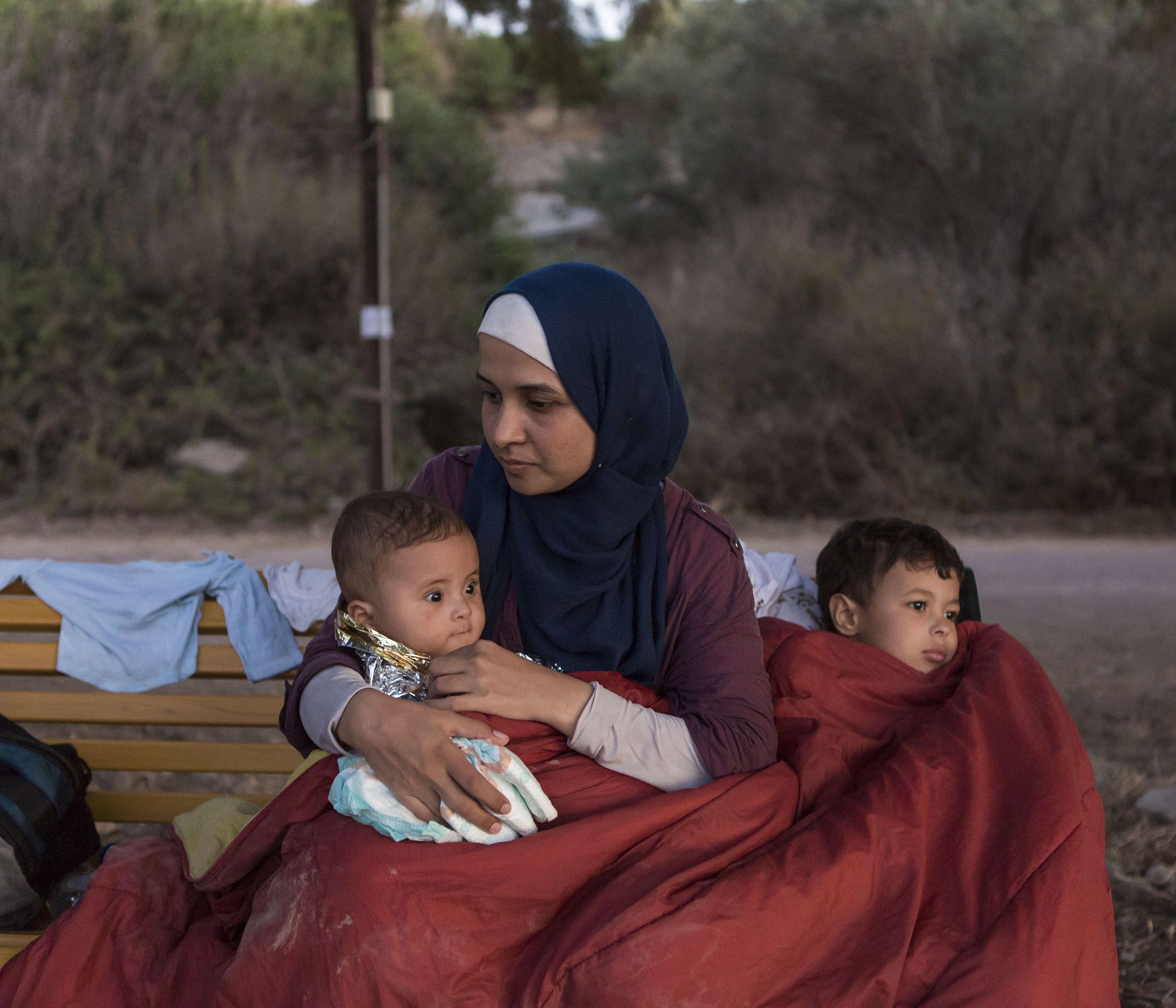 Syrian refugee Asmaa holds her 6-month old baby Osman while her 5-year-old boy Abdul-Rahman sits beside her. Asmaa and her husband Omar fled their home near Damascus over one and half months ago, travelling through Lebanon then onto Turkey before cr