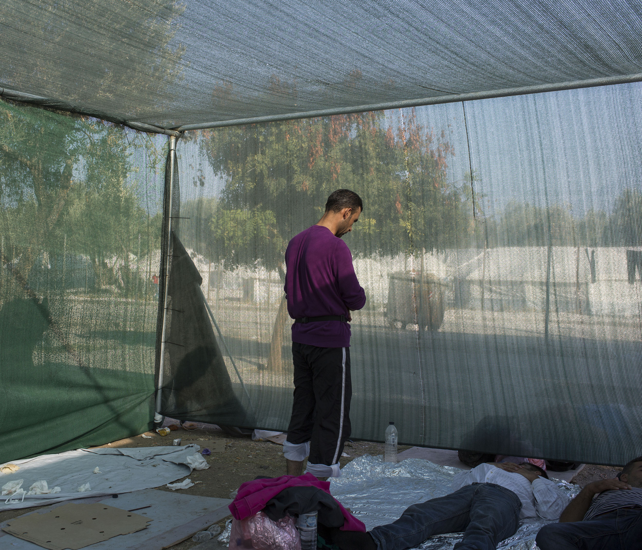 A Syrian refugee prays in the evening at Kara Tepe camp and registration centre near Mytilini.