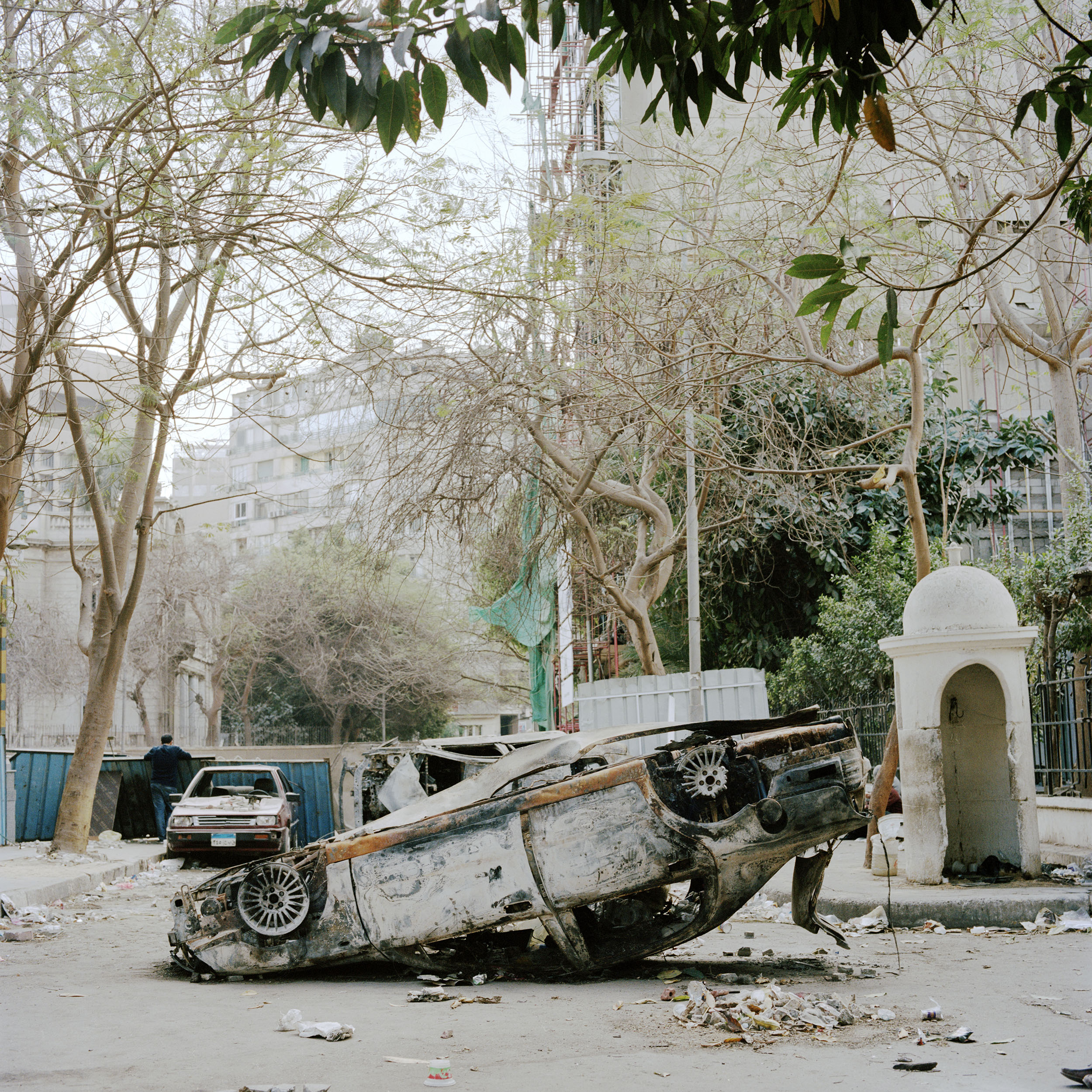  A burnt out car lies in the street outside the Omar Makram mosque in Tahrir square 