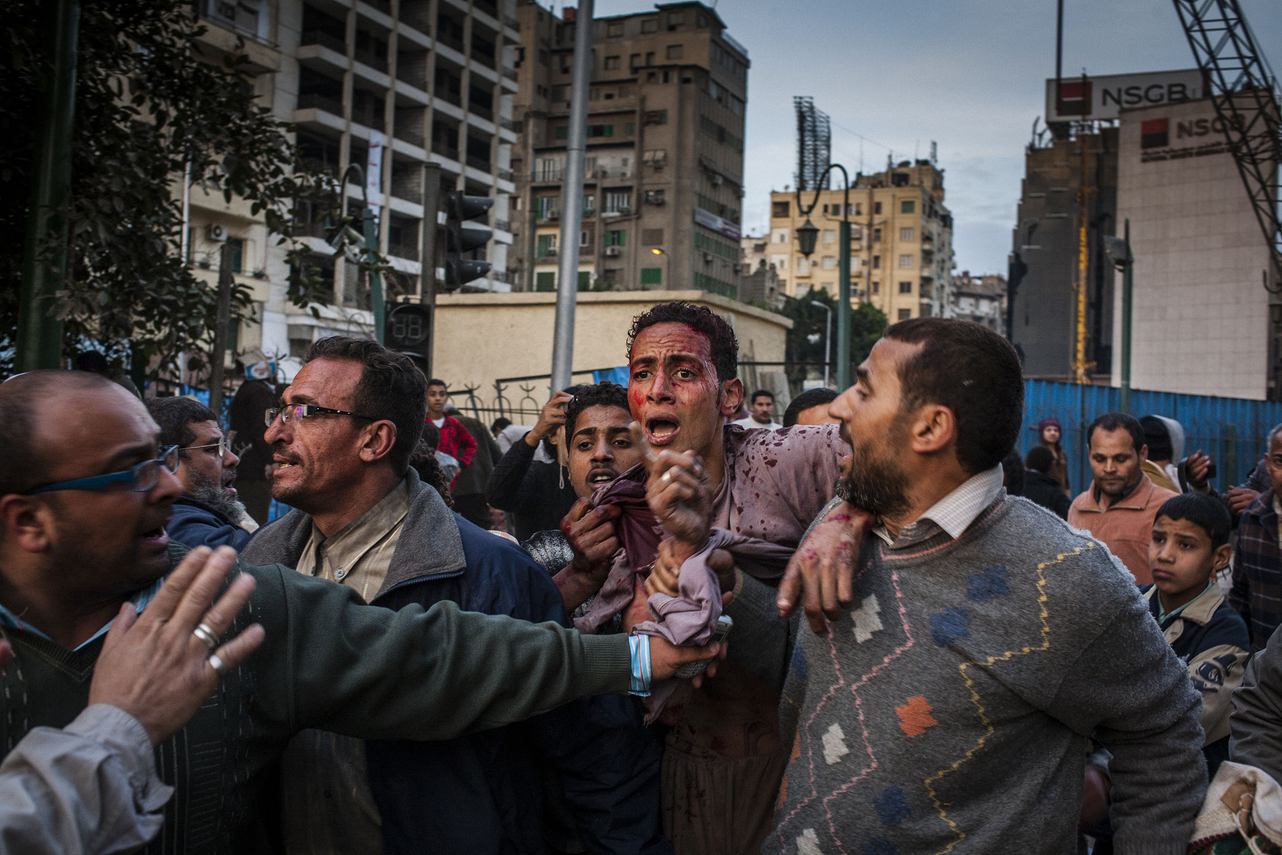  A young Mubarak supporter captured by anti-government protesters is beaten before being taken away outisde the Egyptian Museum in Tahrir Square.  