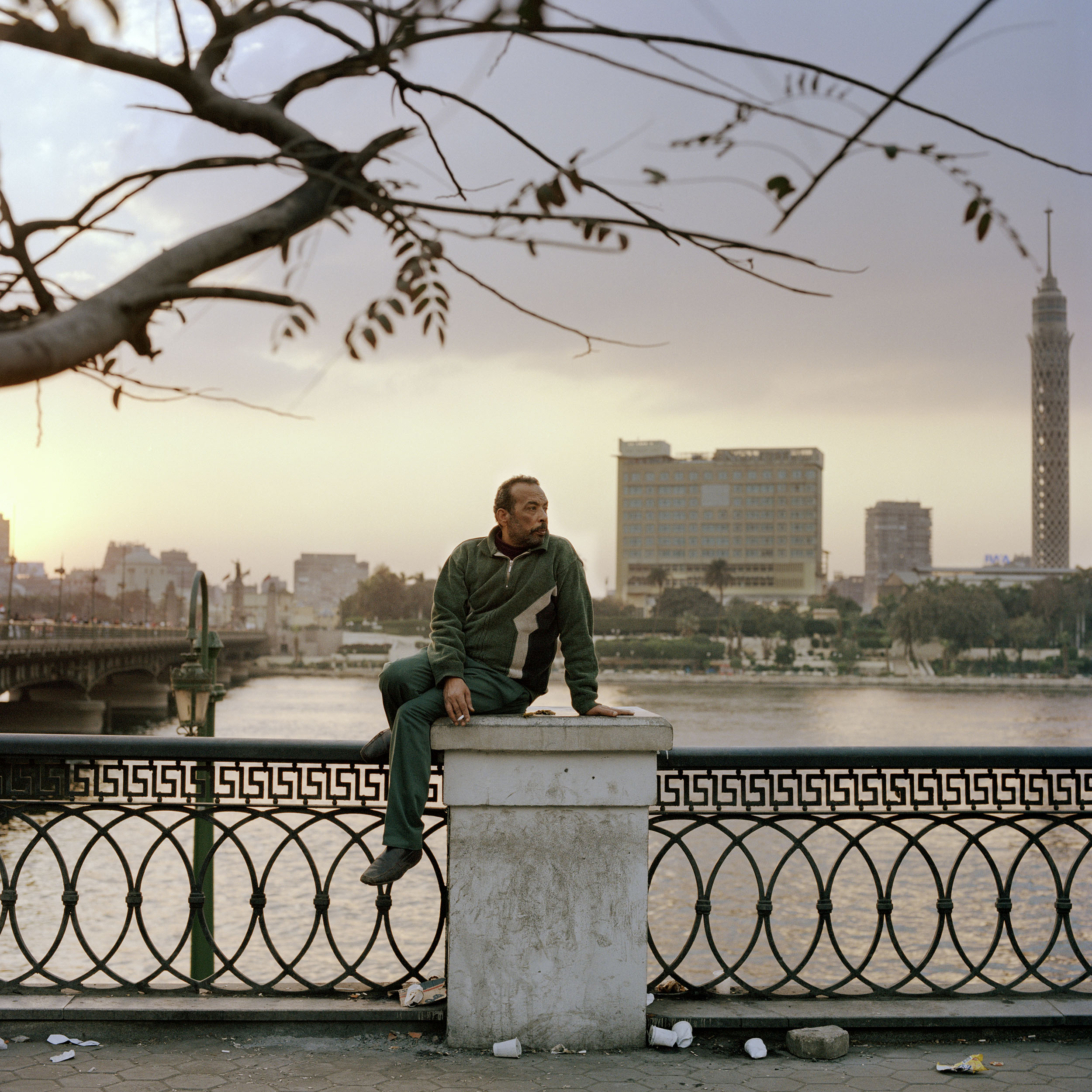  A man sits by the river nile beside Qasir Al Nil bridge, which became the main entry and exit point for anti government protesters. 