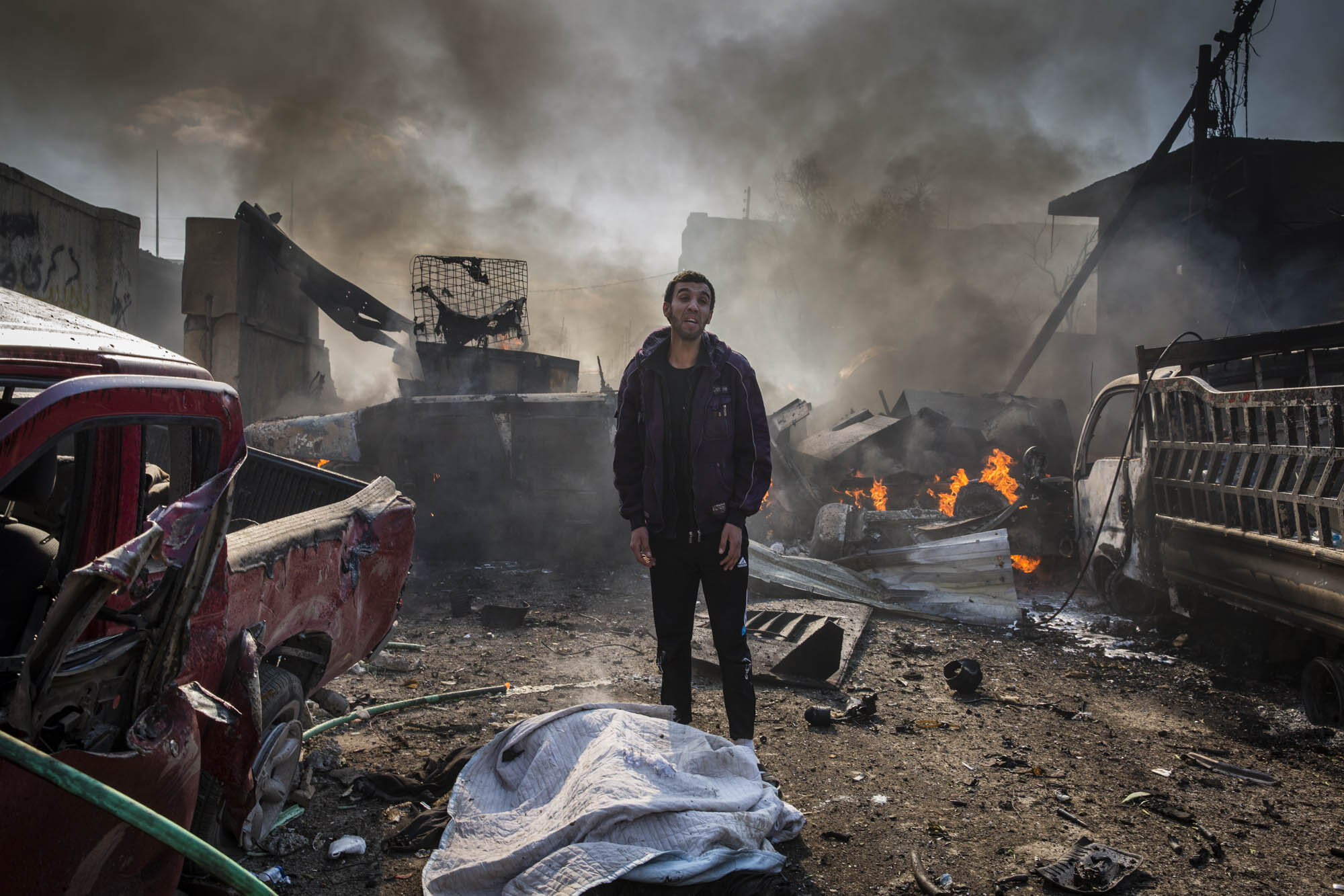  A man called out to his relatives moments after he discovered that his father had been killed by an ISIS suicide car bomb in the Jadidah neighbourhood of west Mosul. Iraq - March 2017 