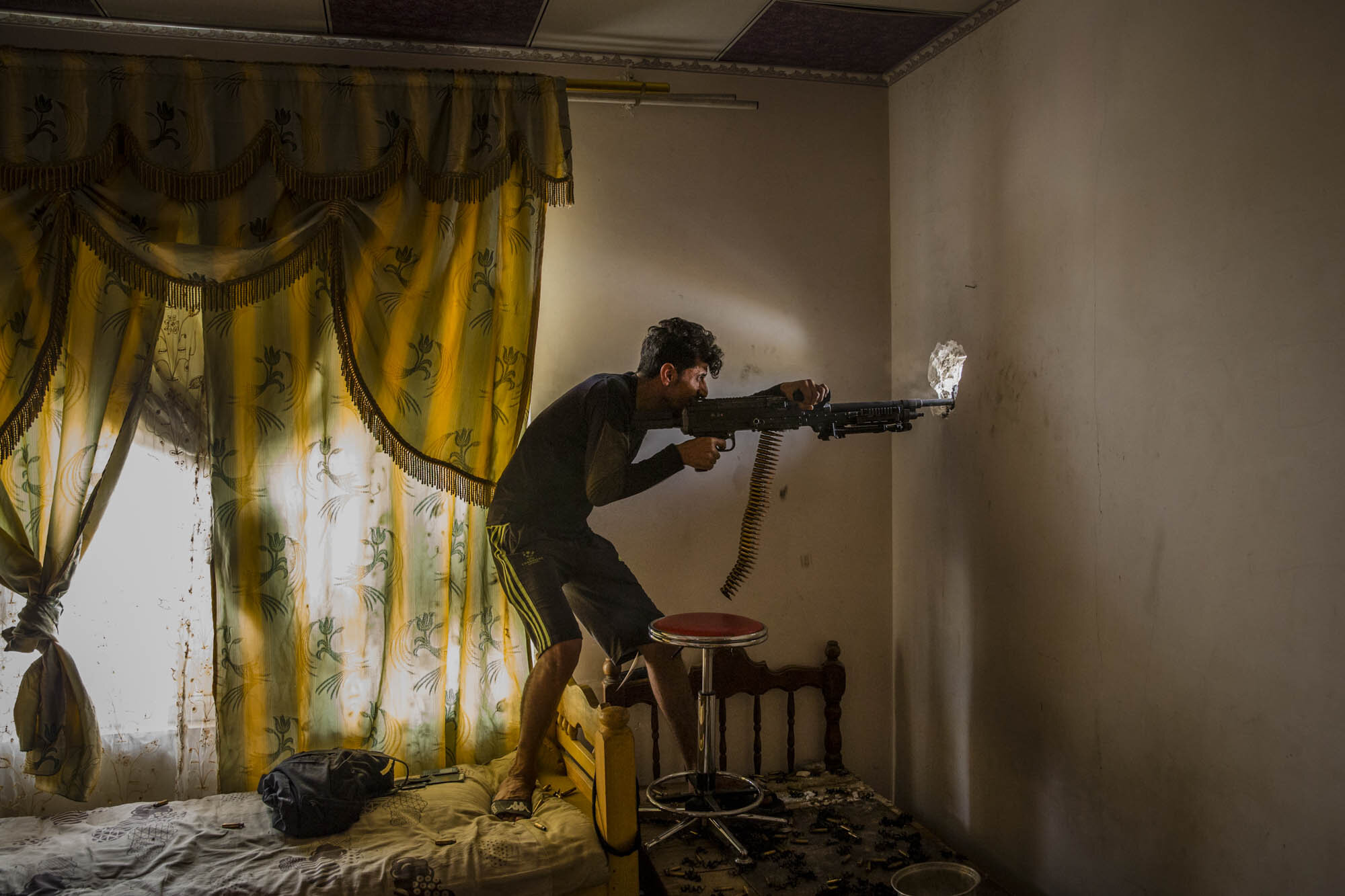  An Iraqi special forces soldier fired on ISIS militants from a defensive position on the edge of the Rifai neighbourhood of west Mosul. Iraq - May 2017 