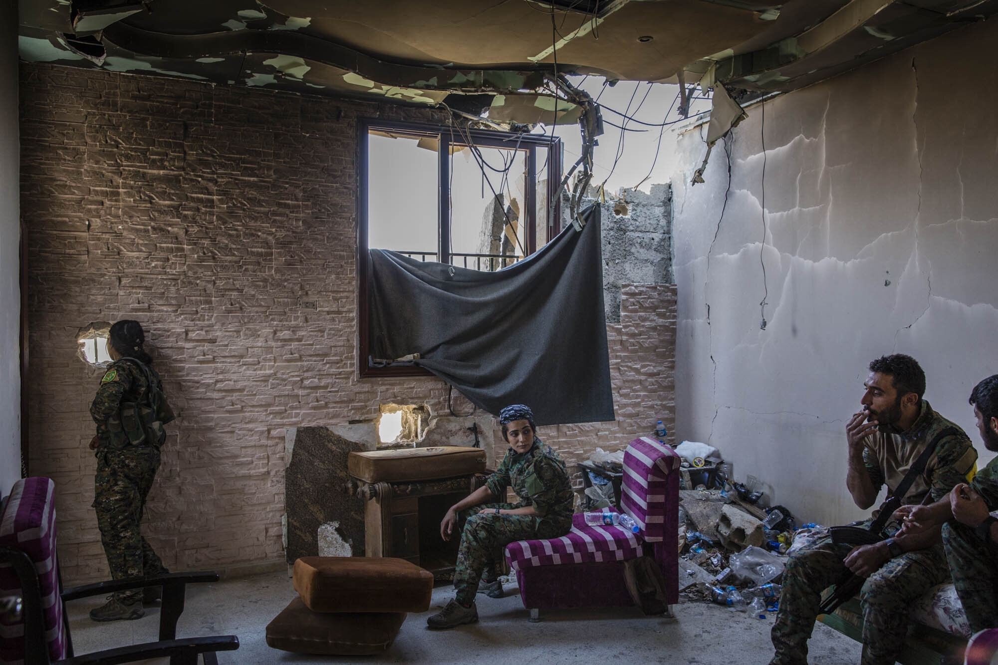  The day before the city was announced liberated from ISIS, SDF soldiers sat in a destroyed building they used as a base in west Raqqa. Syria - Oct 2017 