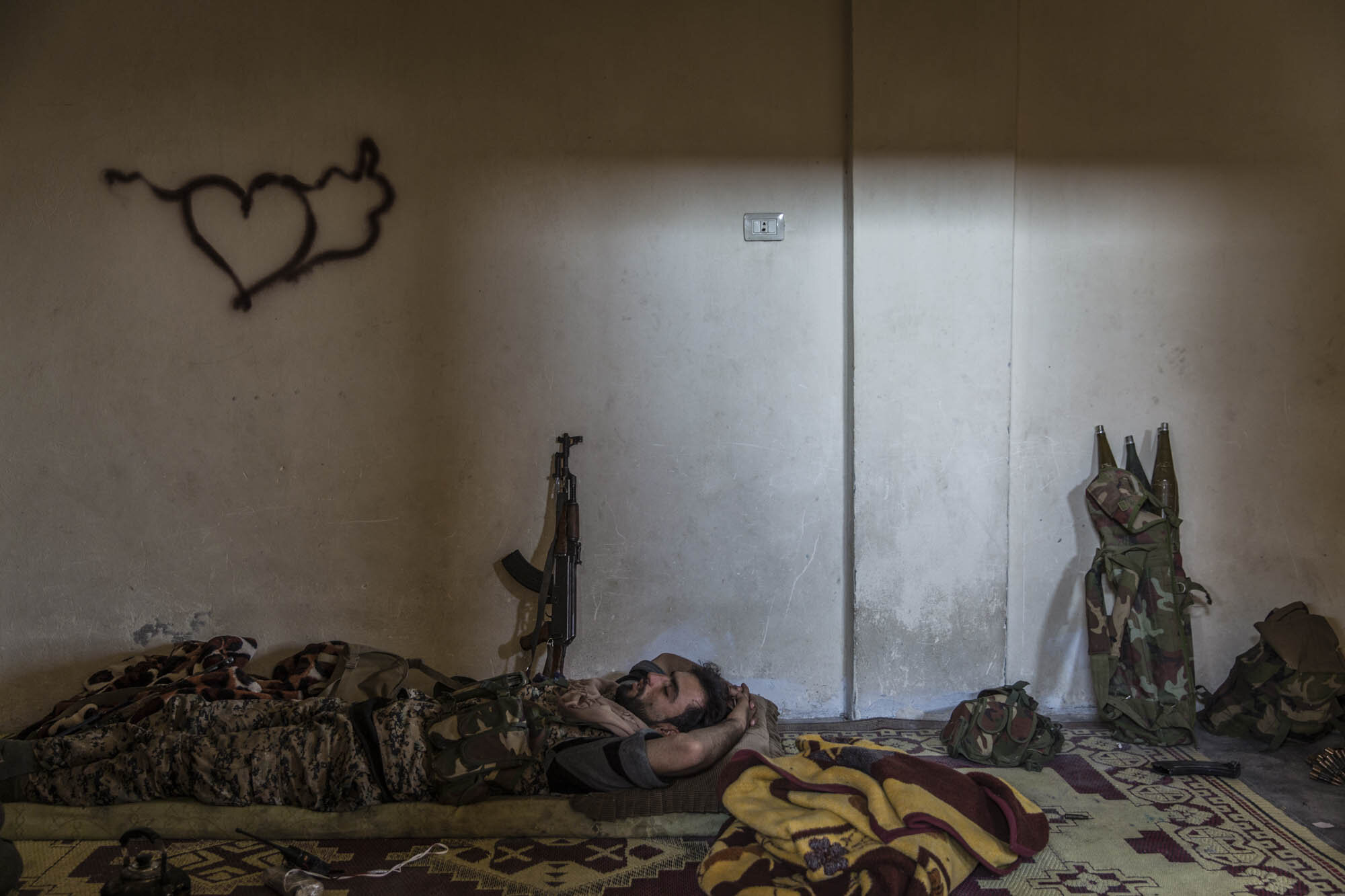  An SDF soldier rested at a base near the frontline in east Raqqa just days before the city fell. Syria - October 2017 