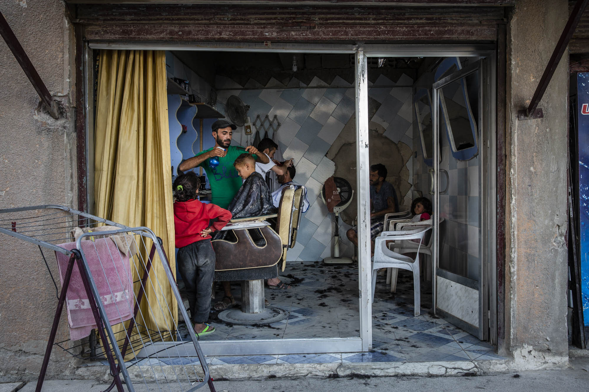  Mohammed Haj Ali was busy in the run up to the Muslim holiday of Eid, cutting the hair of some of the few residents who had returned to his neighbourhood in Raqqa. Syria - June 2018 