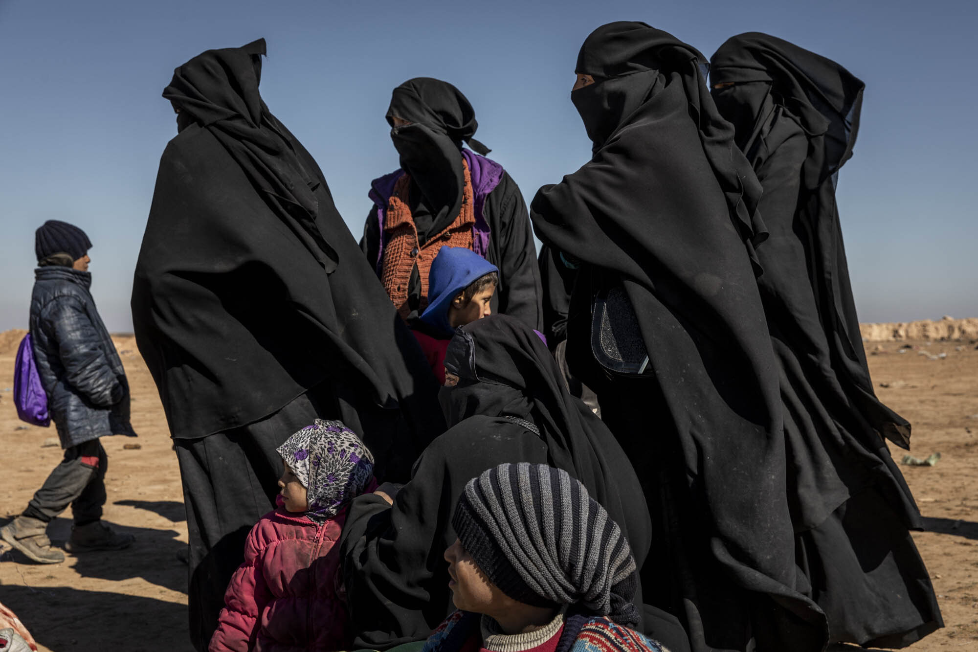  Women and children, suspected of being the wives and family members of ISIS militants, who fled the last ISIS-held area in south east Syria, waited to be screened by Kurdish and coalition forces at a mustering point in the desert near the village of