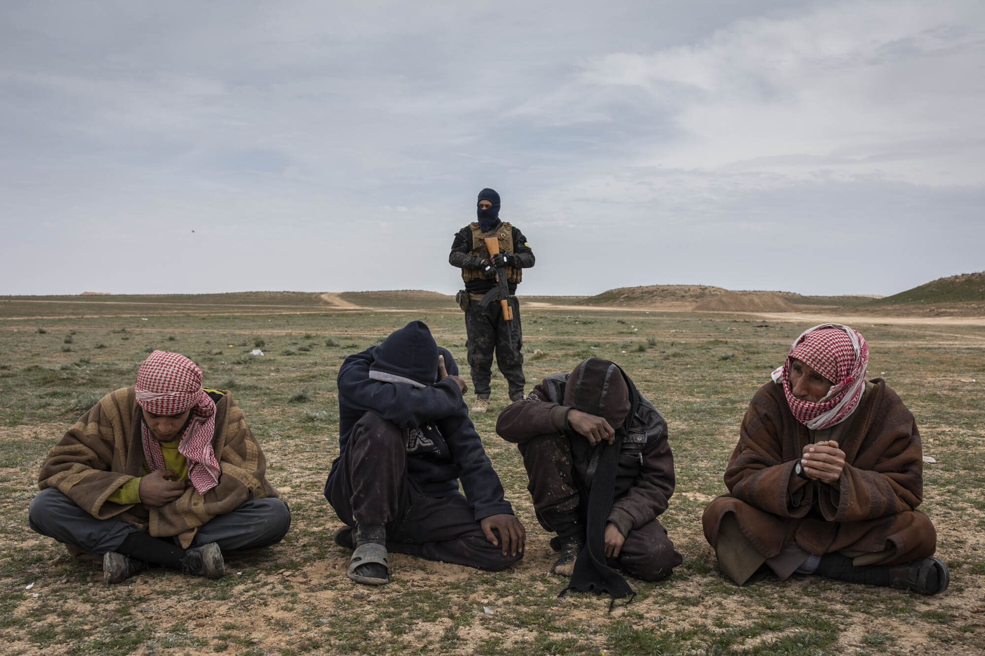  Men who had fled the last area of ISIS control around the village of Baghuz, waited to be questioned about their links to the terror group by American and Kurdish intelligence officers at a screening point in the desert 25km north of the frontline. 