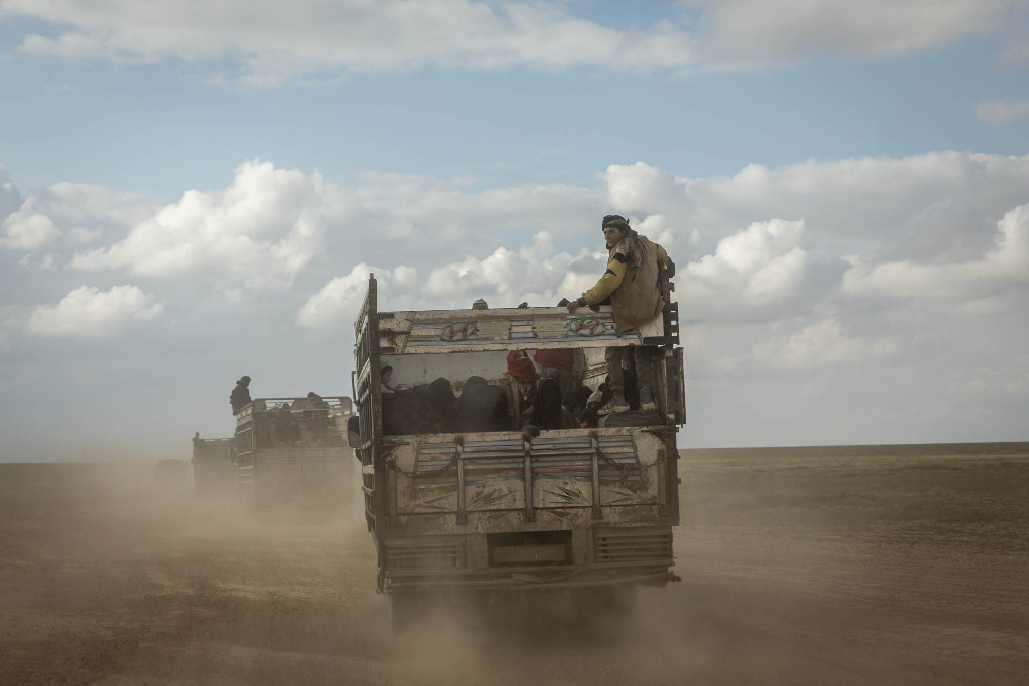  A young boy glared back as the convoy he was travelling in, full of hundreds of people who had been evacuated from the last area of ISIS control in south east Syria, drove through the desert in Deir al-Zour to detention camps further north. 