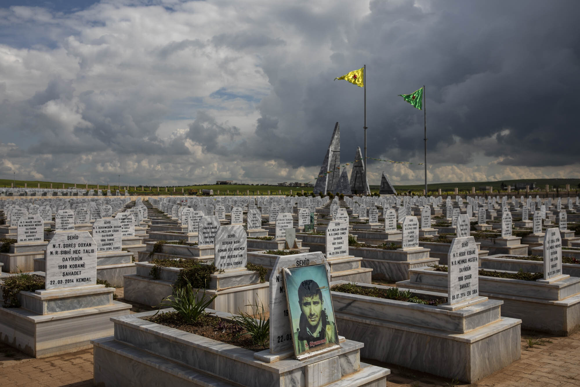 A portrait of a martyred Kurdish fighter, who died during the fight against ISIS, sat amidst a sea of graves at the martyrs cemetery in Kobani, northern Syria. The US backed Syrian democratic forces released a statement claiming that they had lost m