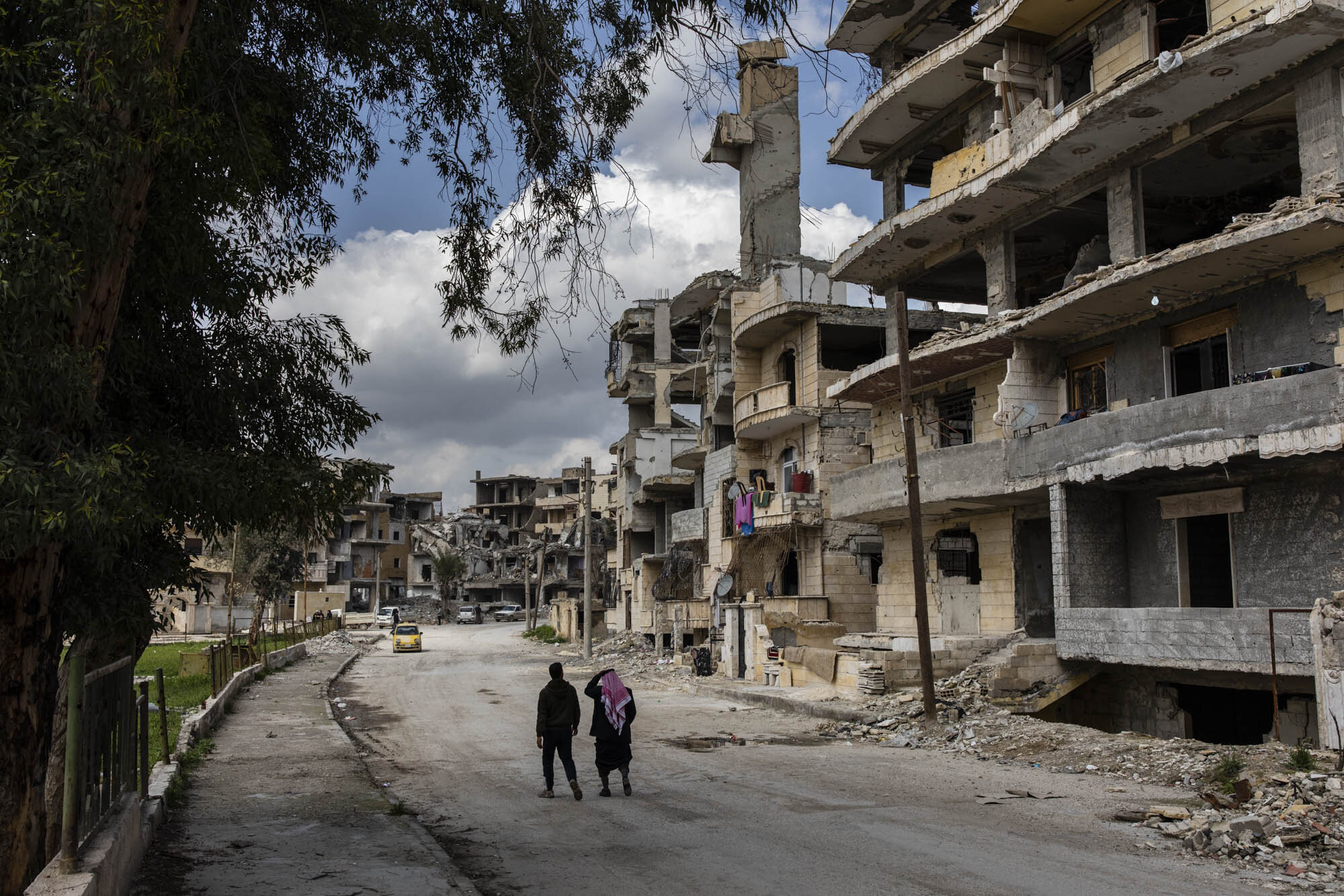  Two men walked through a heavily destroyed neighbourhood in Raqqa, where only four families had returned to live since the cities liberation from ISIS more than a year before. The war to rid Iraq and Syria of ISIS came at a terrible cost.  