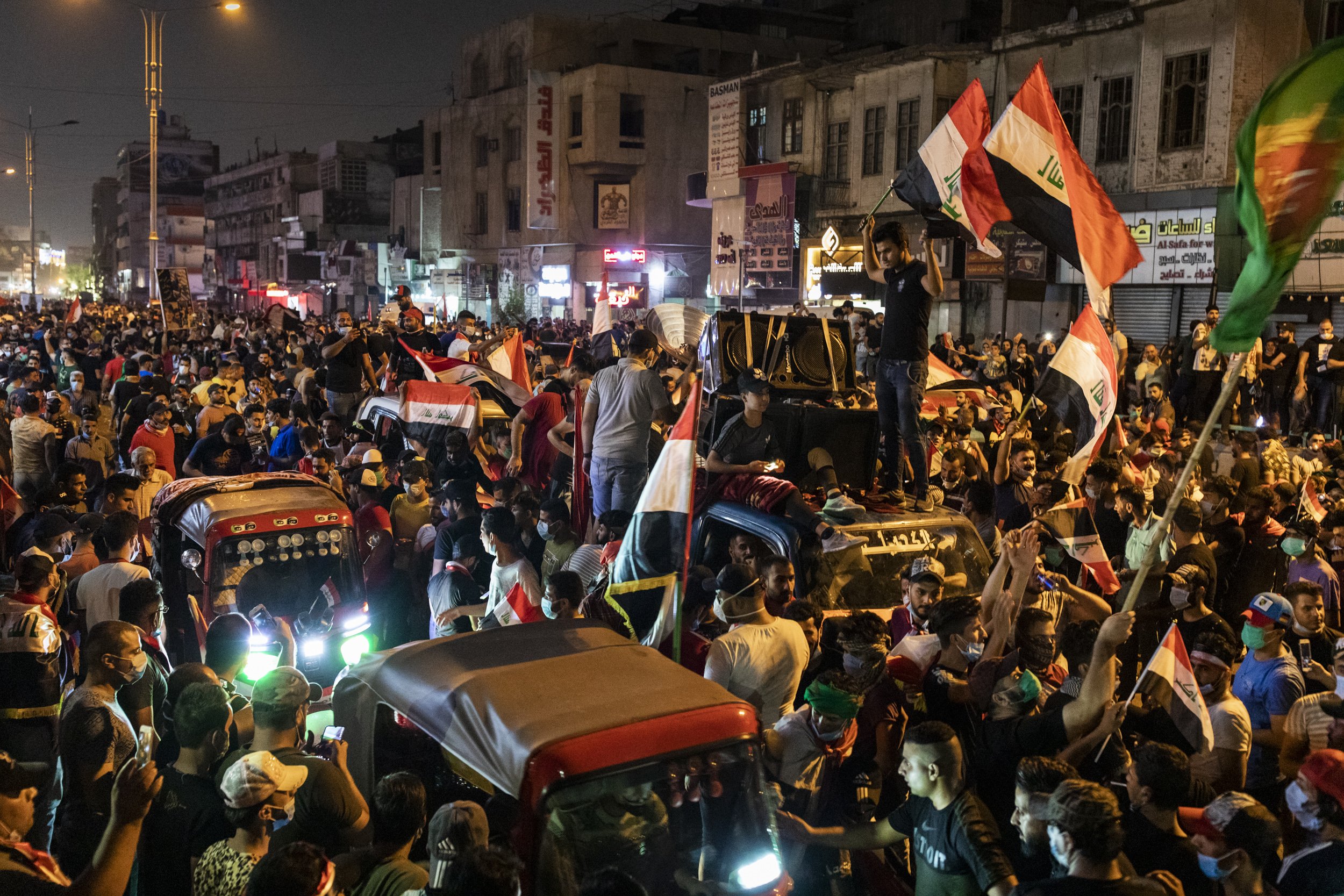  People crowded the streets at night around Tahrir Square, Baghdad, during the height of anti-government protests in Iraq in late October. 