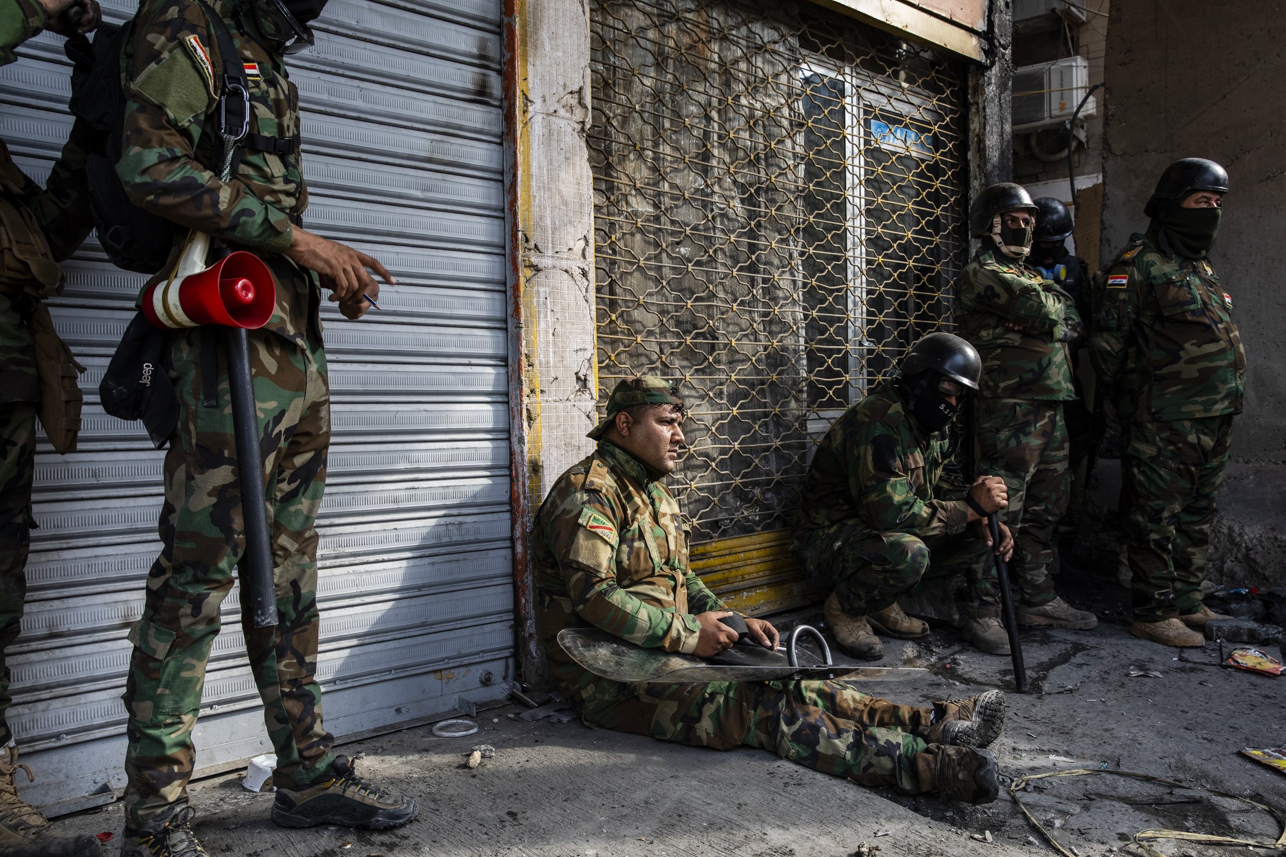  Iraqi security forces soldiers rested during clashes with groups of mainly teenage boys . 