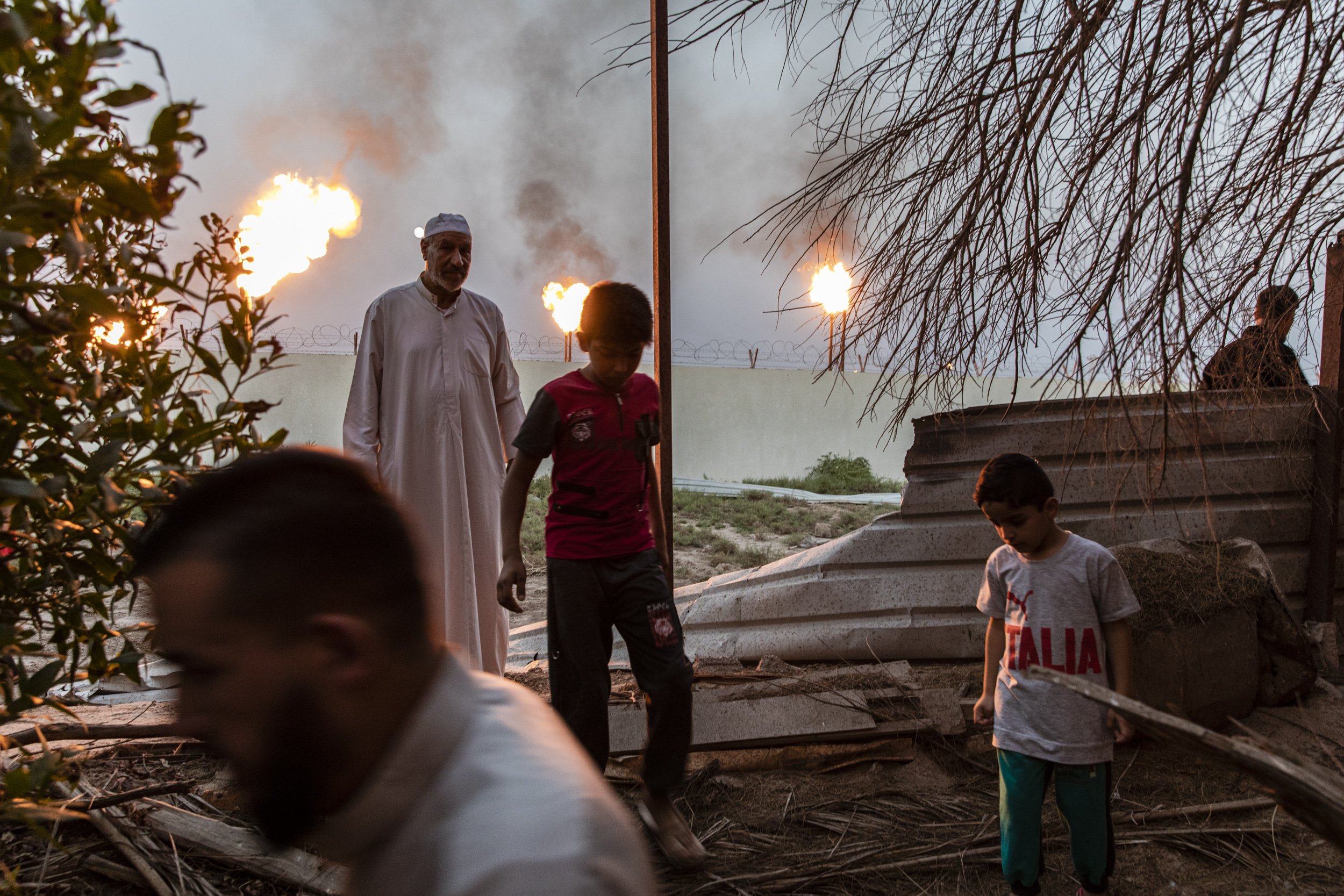 Local men from villages surrounding the Nahr Bin Omar Oil refinery in Basra, showed how close the refineries gas burn-off flares came to some of their houses.