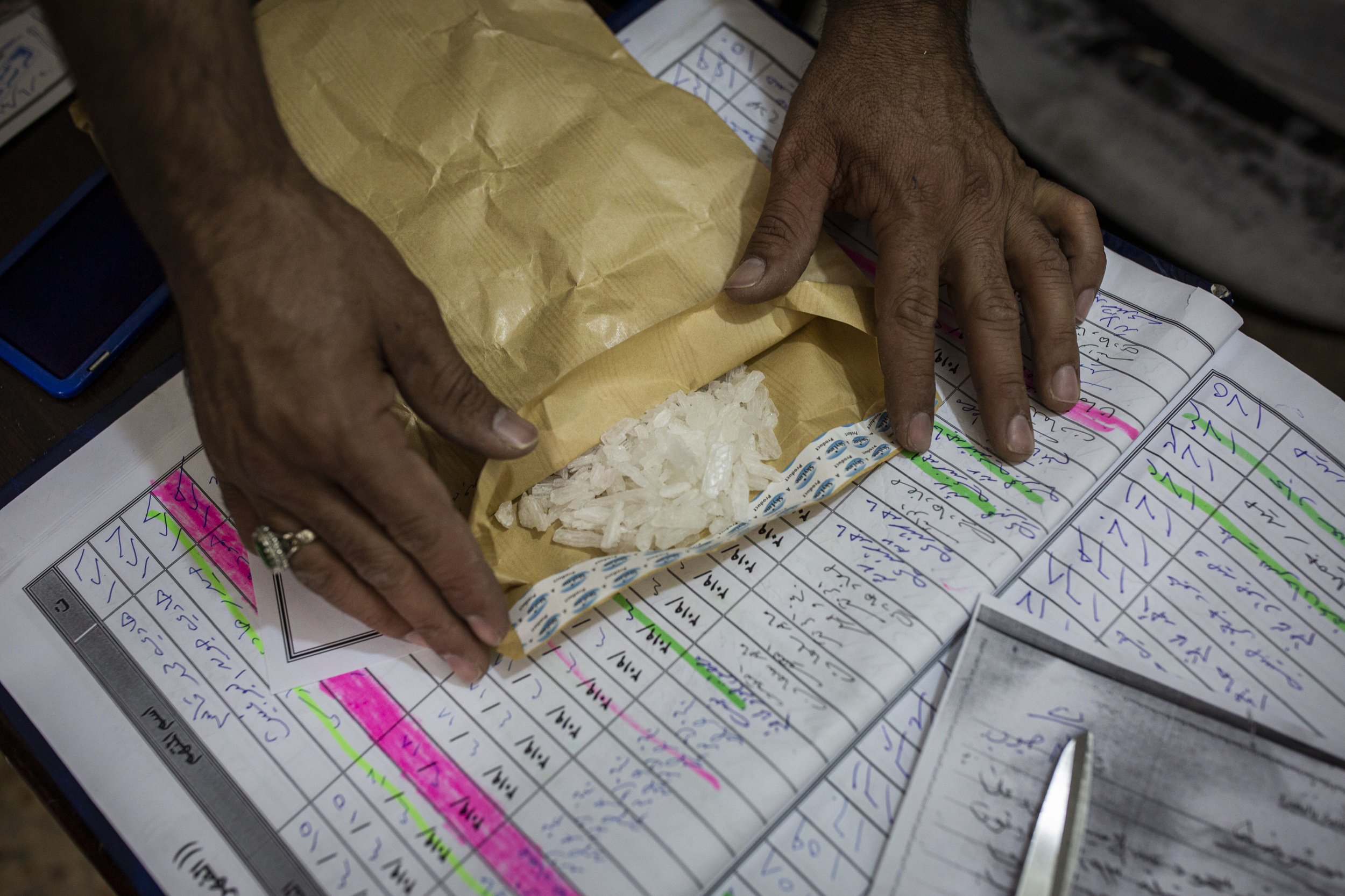  A police officer with a specialised narcotics unit showed off some recently seized crystal meth that was intended for sale in the southern Iraqi province of Basra. 