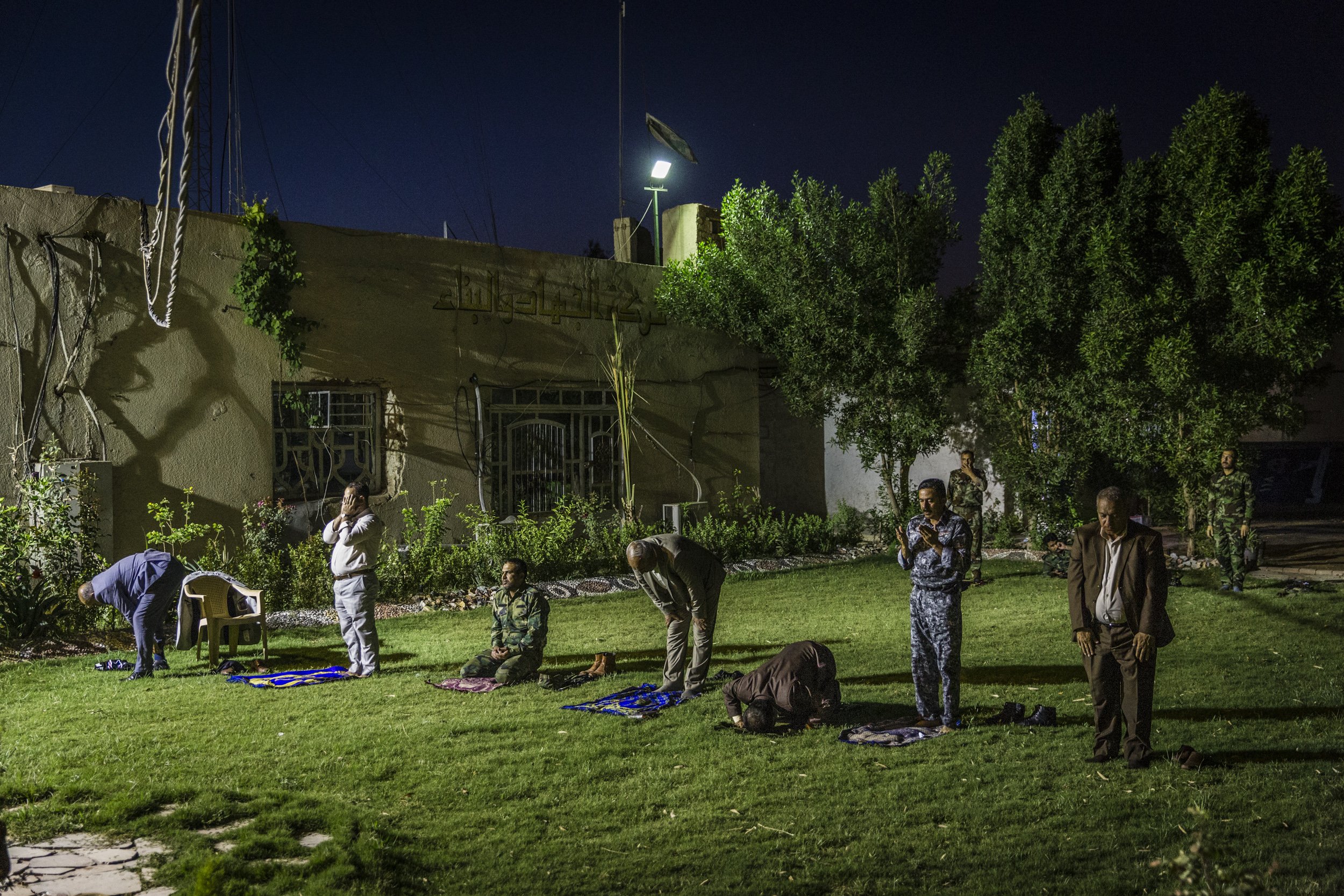 Fatah party men and militia fighters prayed at the end of the day on the campaign trail in Hillah with Fatah party leader Hadi al-Ameri.