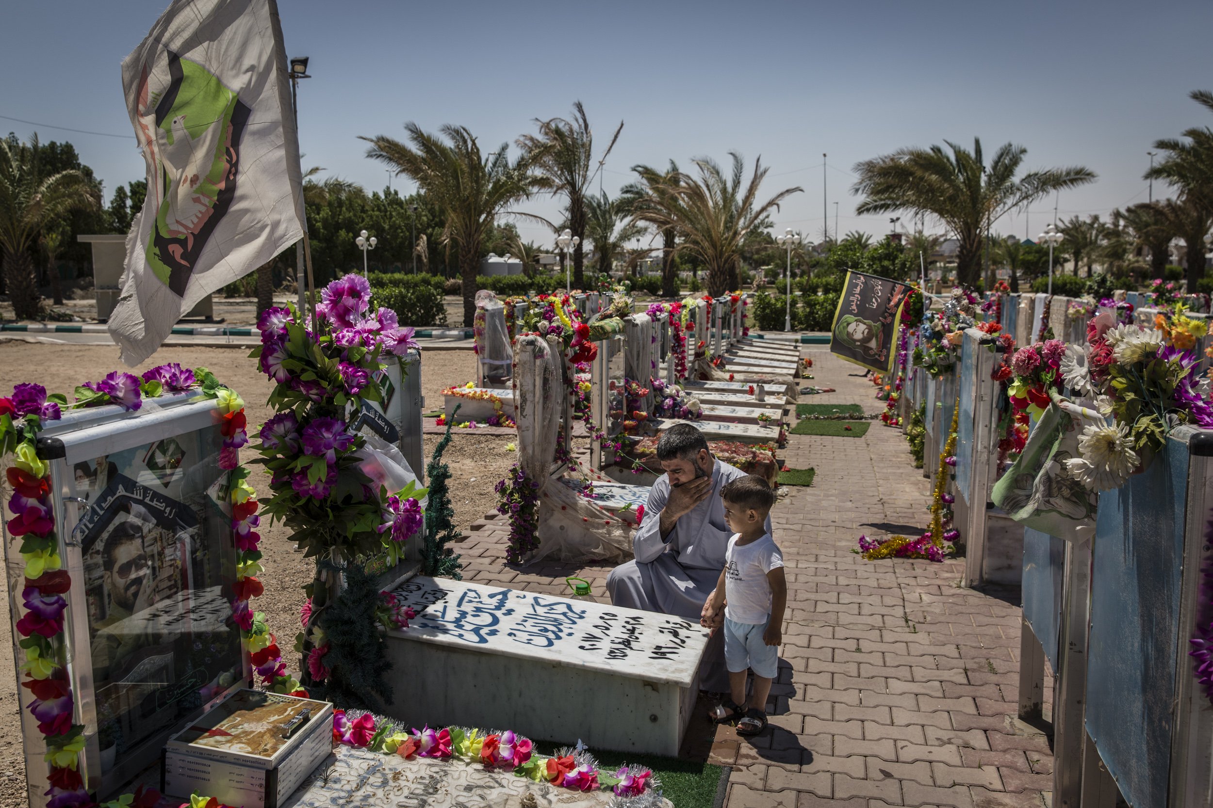  A man visited the grave of his brother, who died fighting ISIS in 2015, at the martyrs cemetery for members of the powerful Shiite militia group Soraya Salam.  