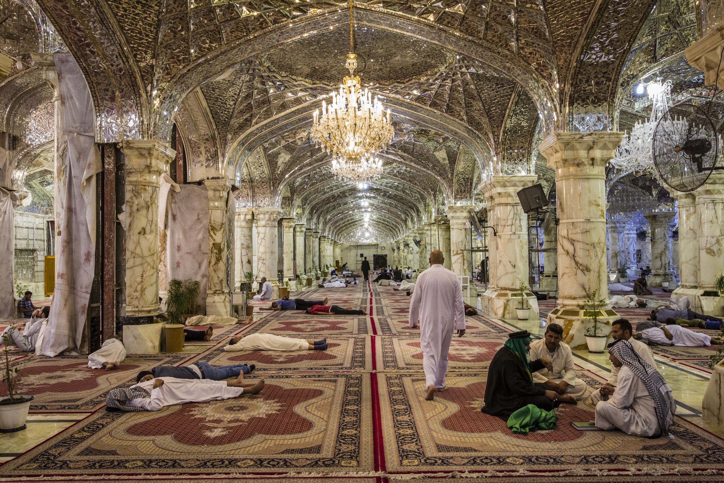  Shiite pilgrims slept and talked inside one of the cavernous halls of the Shrine of Imam Ali, one of the holiest sites in Shia’ism in Najaf, Iraq. 