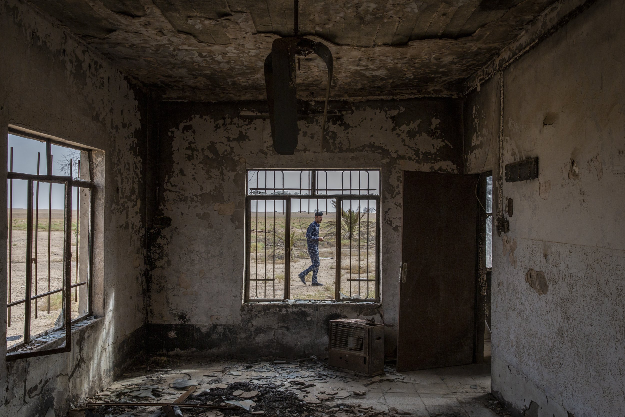  An Iraqi federal police soldier walked past the burnt out home where al-Baghdadi was born in the village of Jallam near Samarra. 