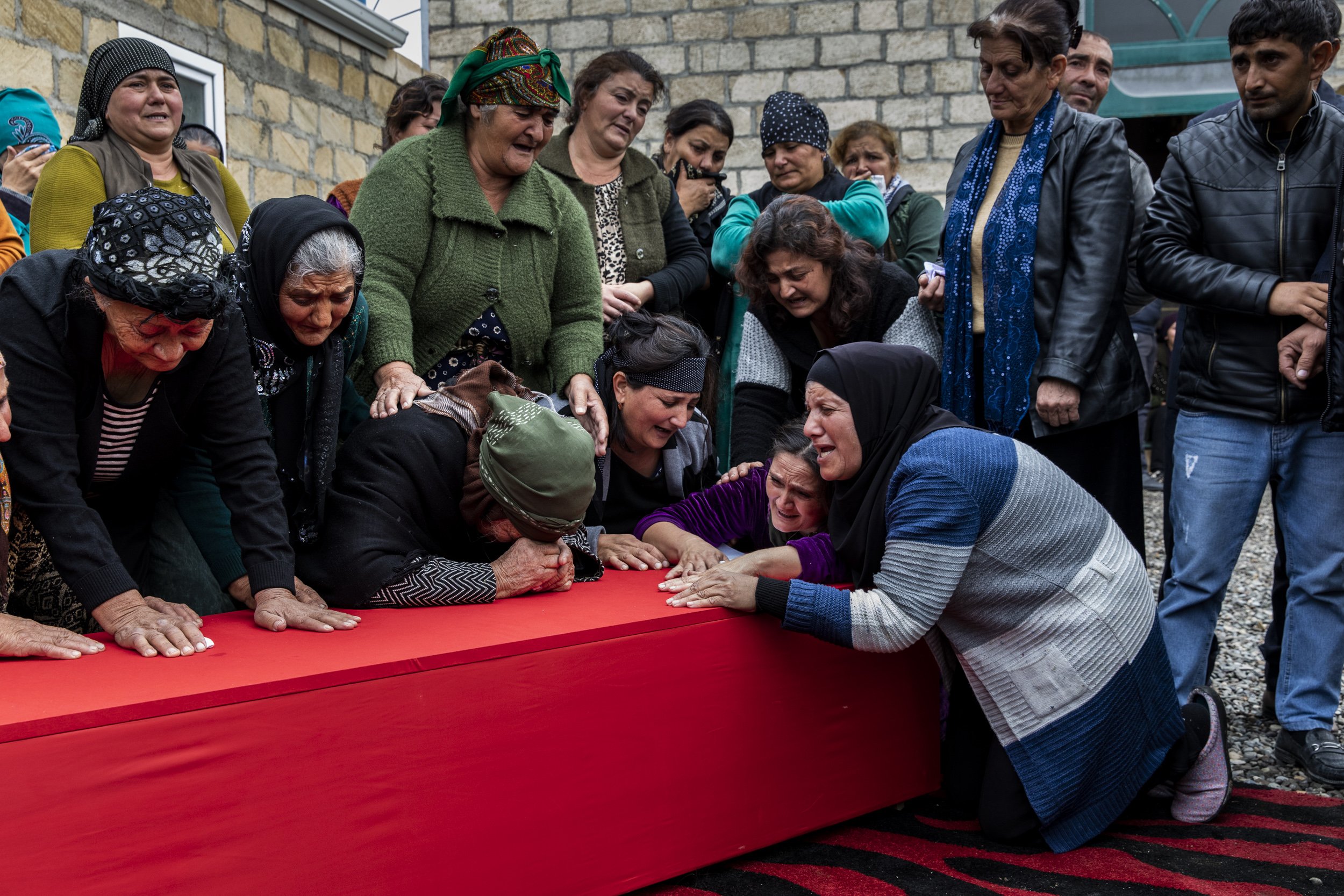  Female family members cried over the coffin of Amar Isakli, a 23 year old soldier in the Azerbaijani army who died after a shell fired by Armenian forces hit a neighbours house in the village of Jemilli near the frontline city of Terter. 