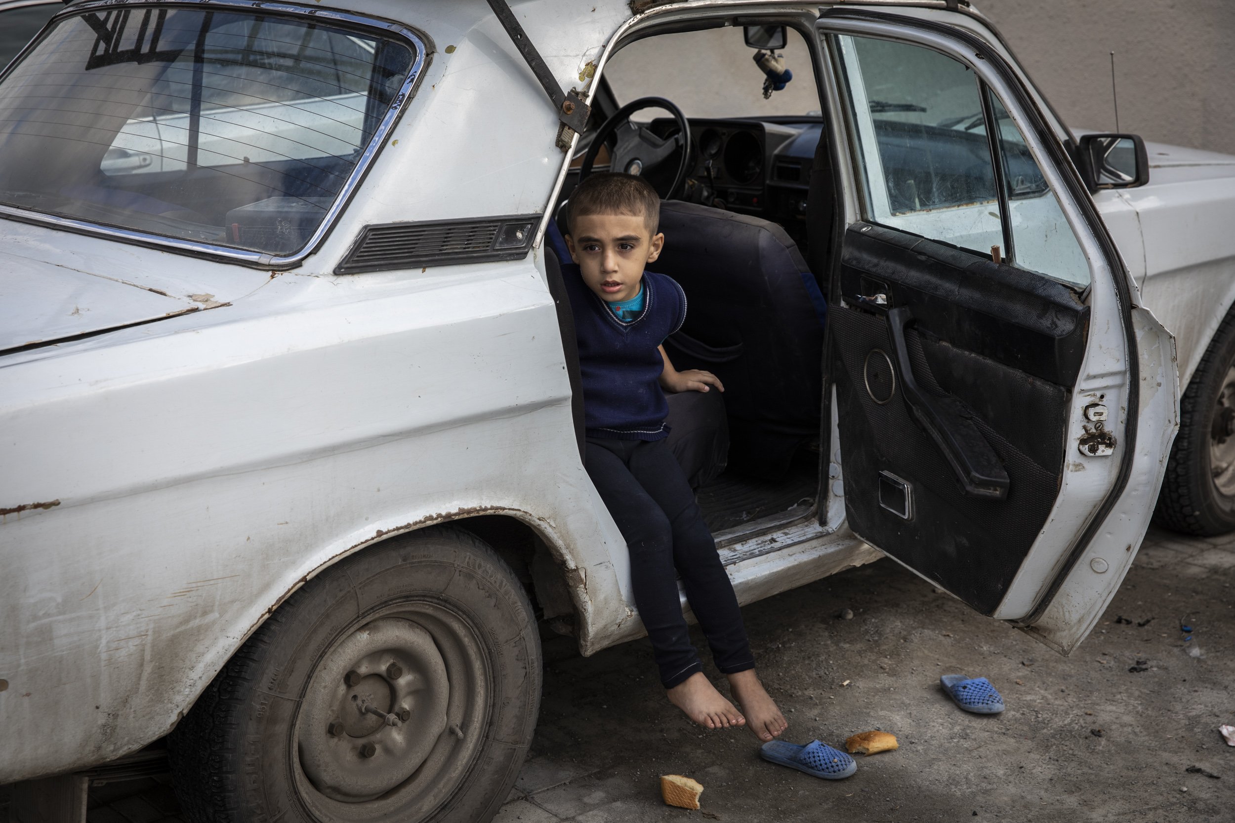 A young boy sat in a car outside a school in the city of Barda that has been turned in to a shelter for people who have been displaced by fighting in the frontline towns and villages around Terter and Agdam.