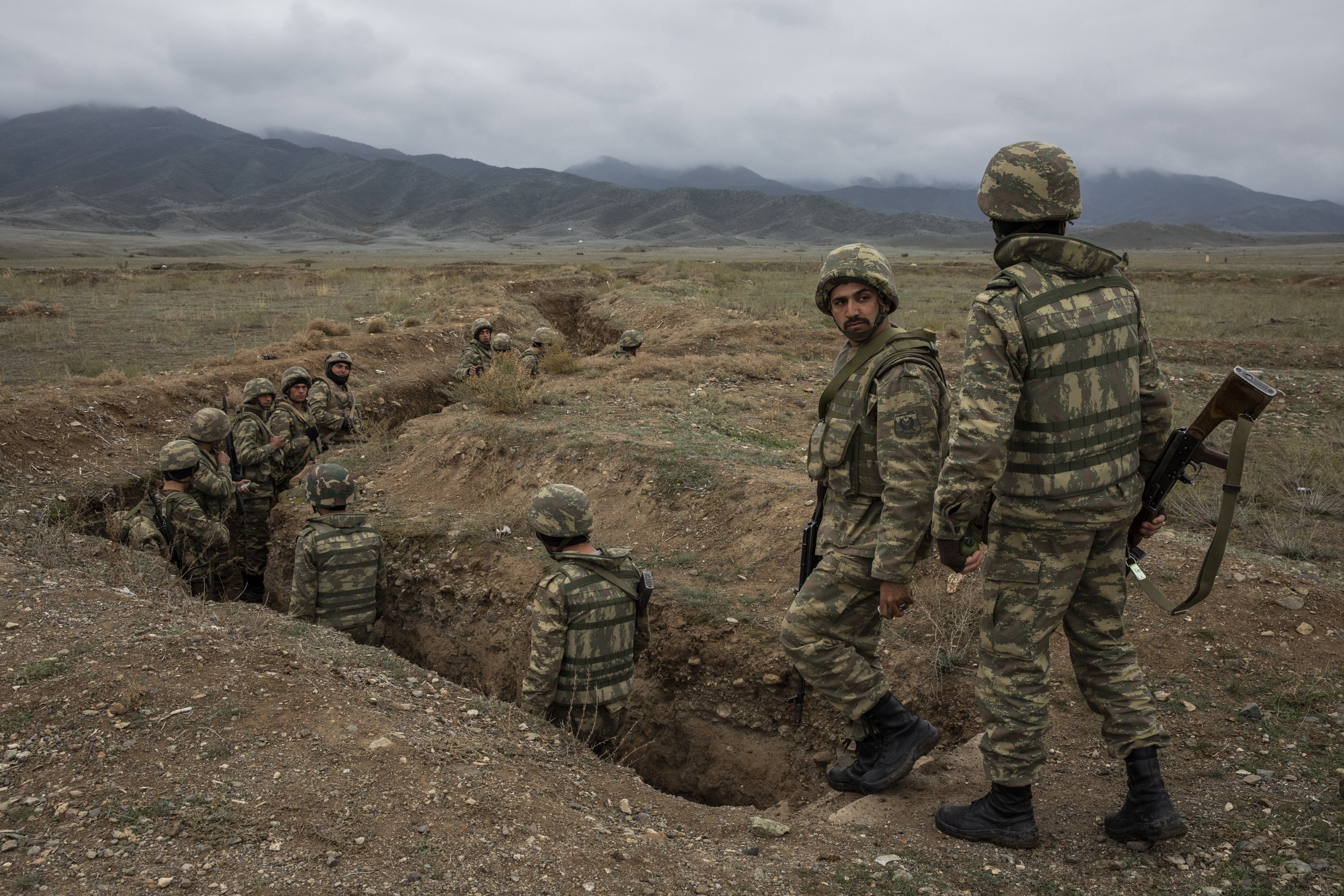  Azerbaijani soldiers walked down into a trench during a training exercise on a base near the frontline somewhere in central Azerbaijan. Many of the young men had already been fighting on the frontline and were on standby waiting to be called up agai