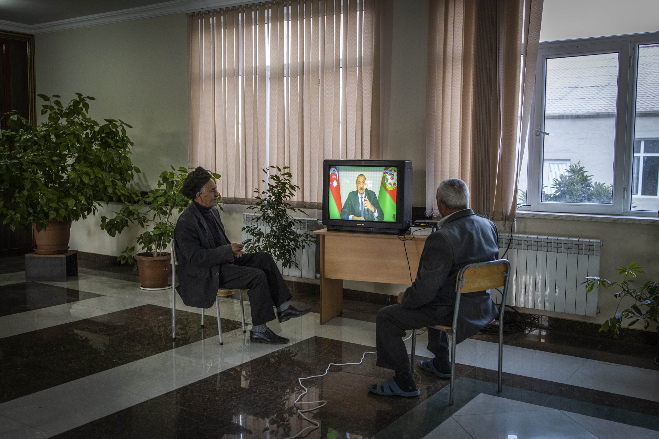  Two elderly men watched news of President Aliyev’s latest address to the nation at a school in the city of Brada that has been turned in to a shelter for people who have been displaced by fighting in the frontline towns and villages around Terter an
