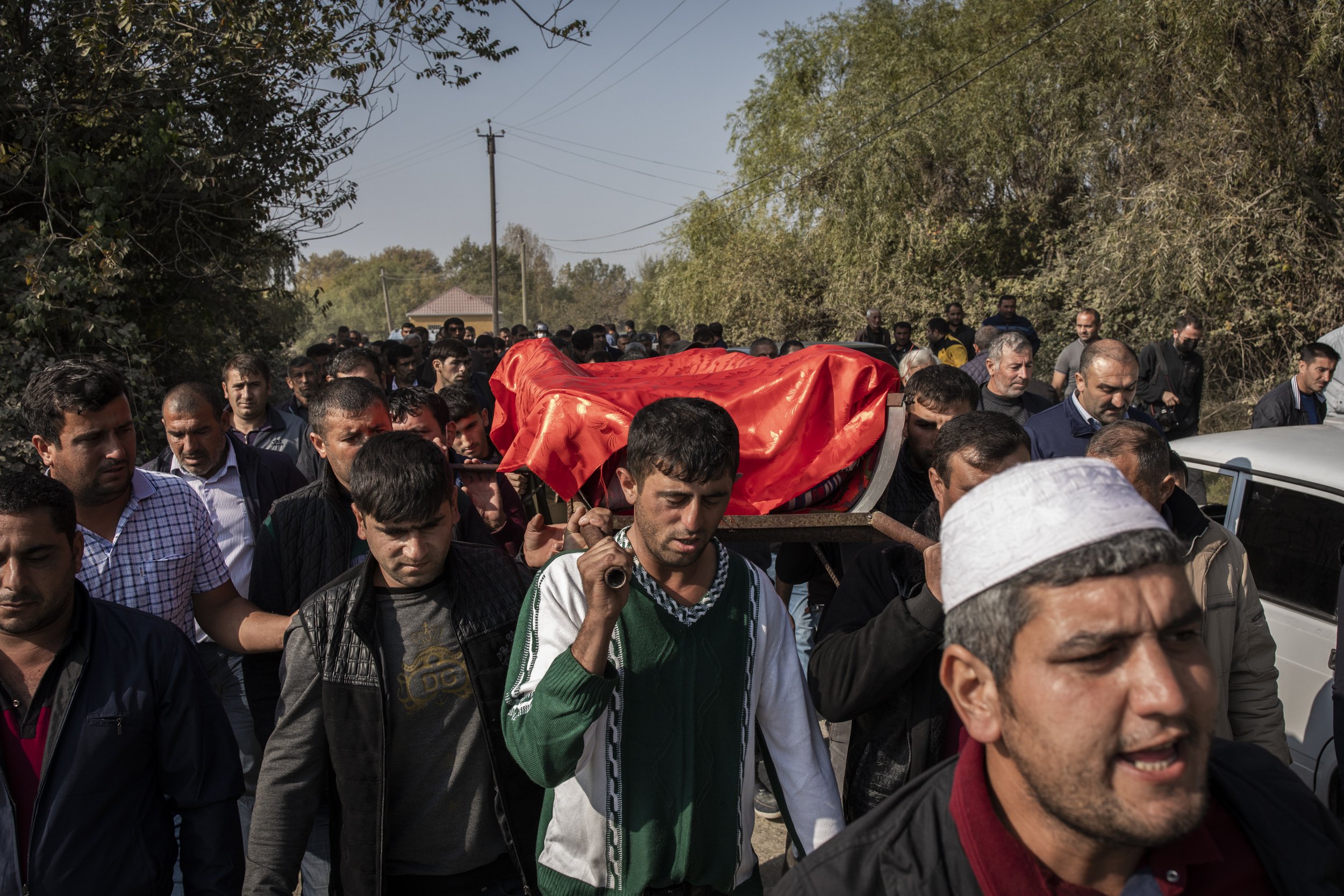  Rovshen Iskandarova (centre) helped carry the coffin of his 7-year-old daughter Aysu who was killed the day before in an Armenian rocket attack in the village of Qarayusifli, near the city of Barda. 