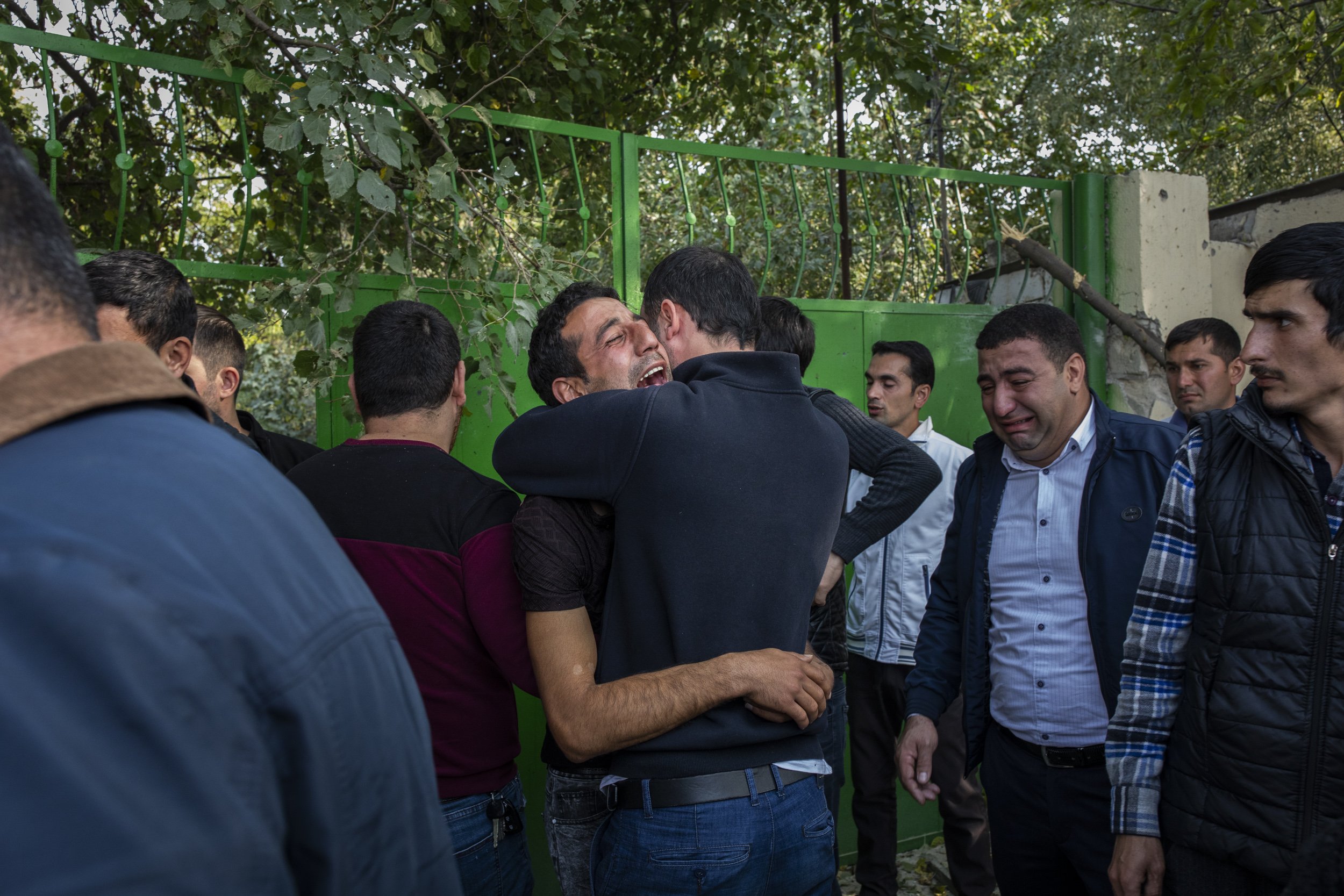 Friends and family members cried over the body of Fuad Ismayilov, 31, who was killed moments earlier in a rocket launched by Armenian forces on the city of Barda in Azerbaijan.