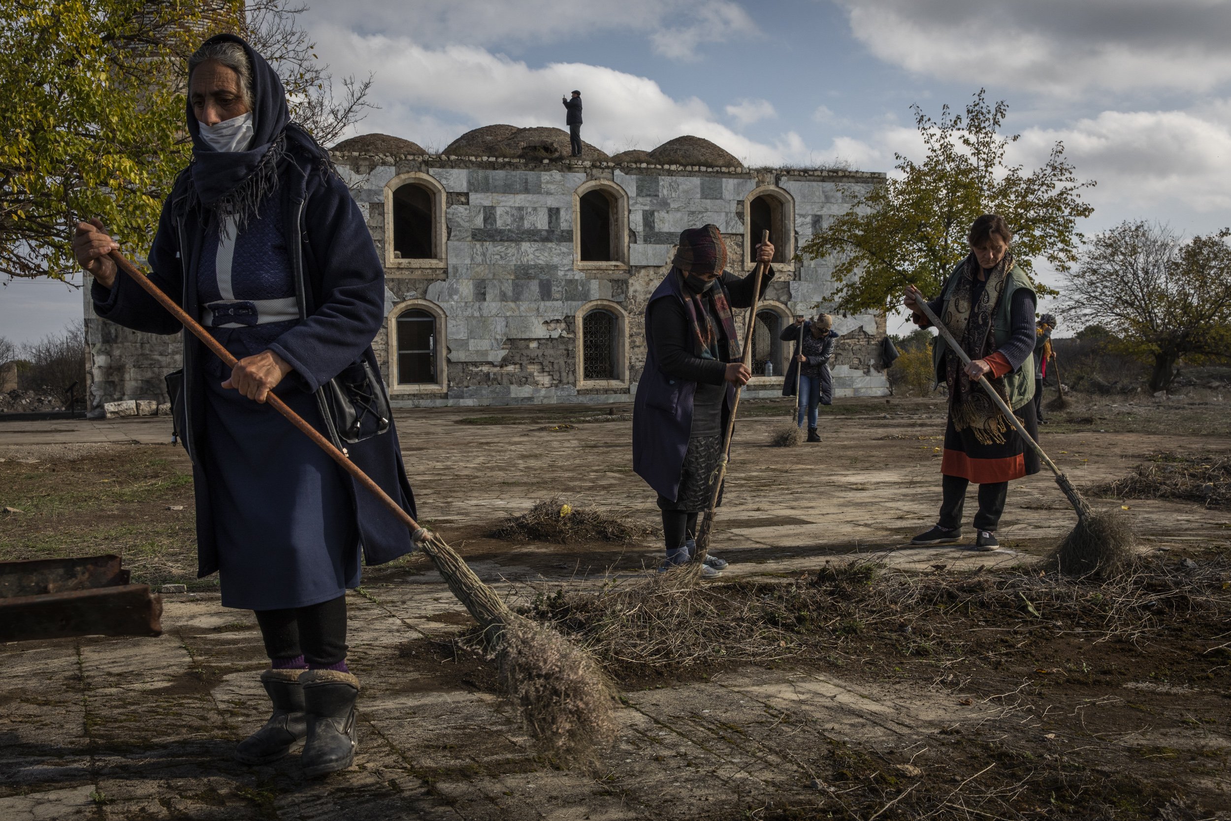  Civilian workers cleaned up the grounds around the mosque in Agdam the day before the president of Azerbaijan was due to visit the area. Agdam the surrounding district had been handed back to Azerbaijan after nearly 30 years of Armenian control. 