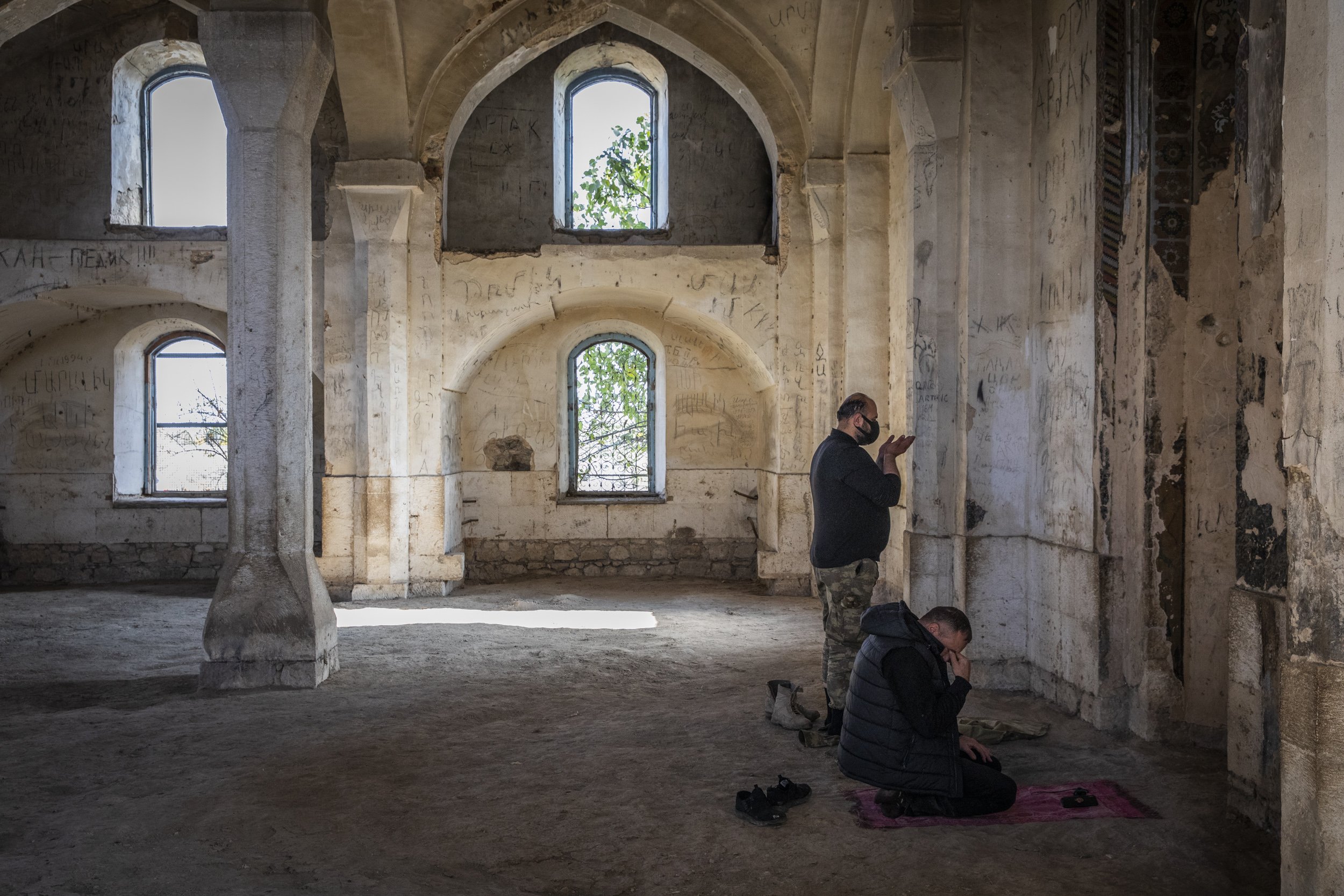  An Azerbaijani soldier and a man dressed in civilian clothing prayed at the mosque in Agdam city, which had been handed back to Azerbaijan after nearly 30 years of Armenian control. The mosque was reported to be the only structurally intact building