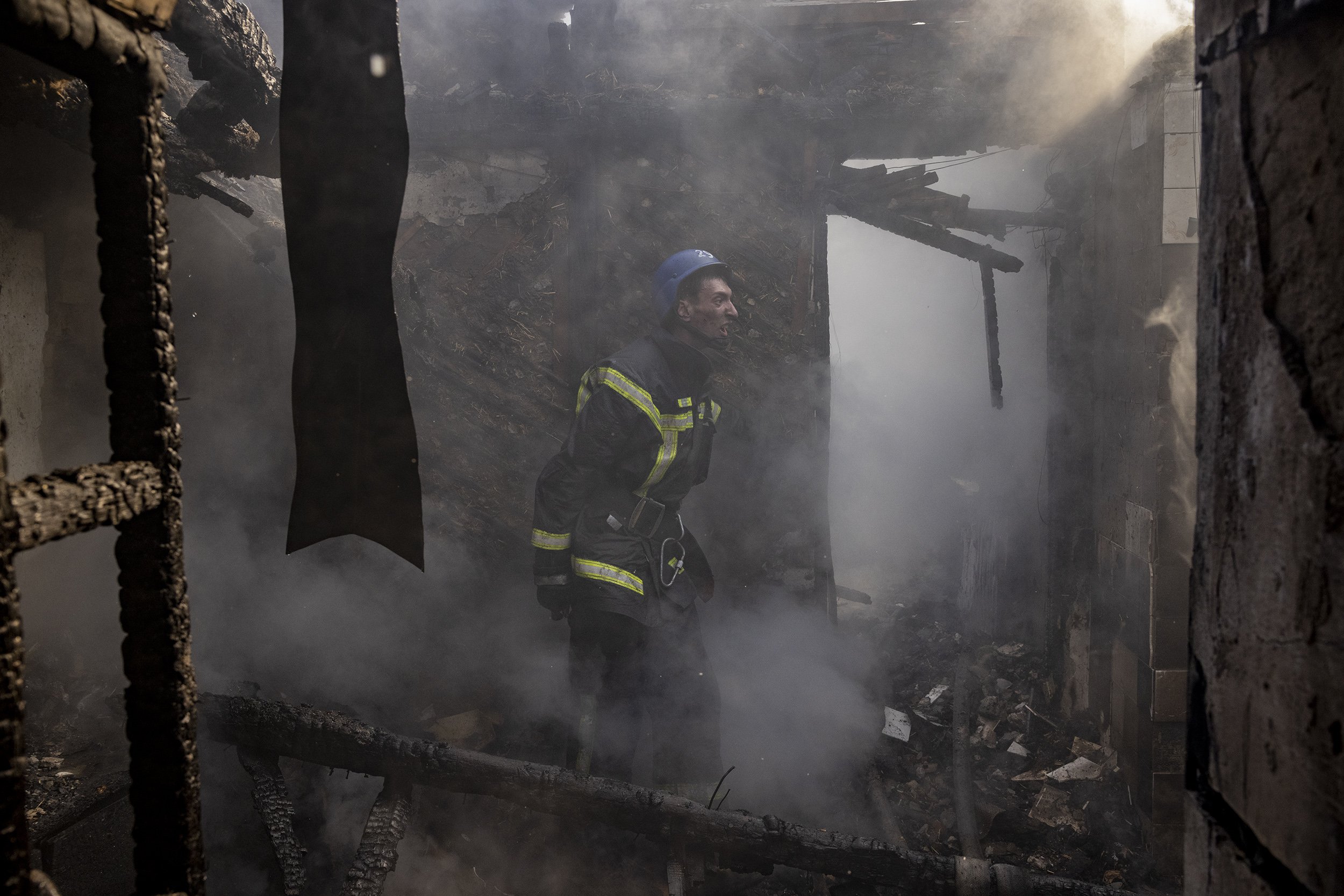  Firefighters battled to put out a blaze in a residential area after an early morning Russian bombardment in the Nyvky district of western Kyiv. March, 2022. 