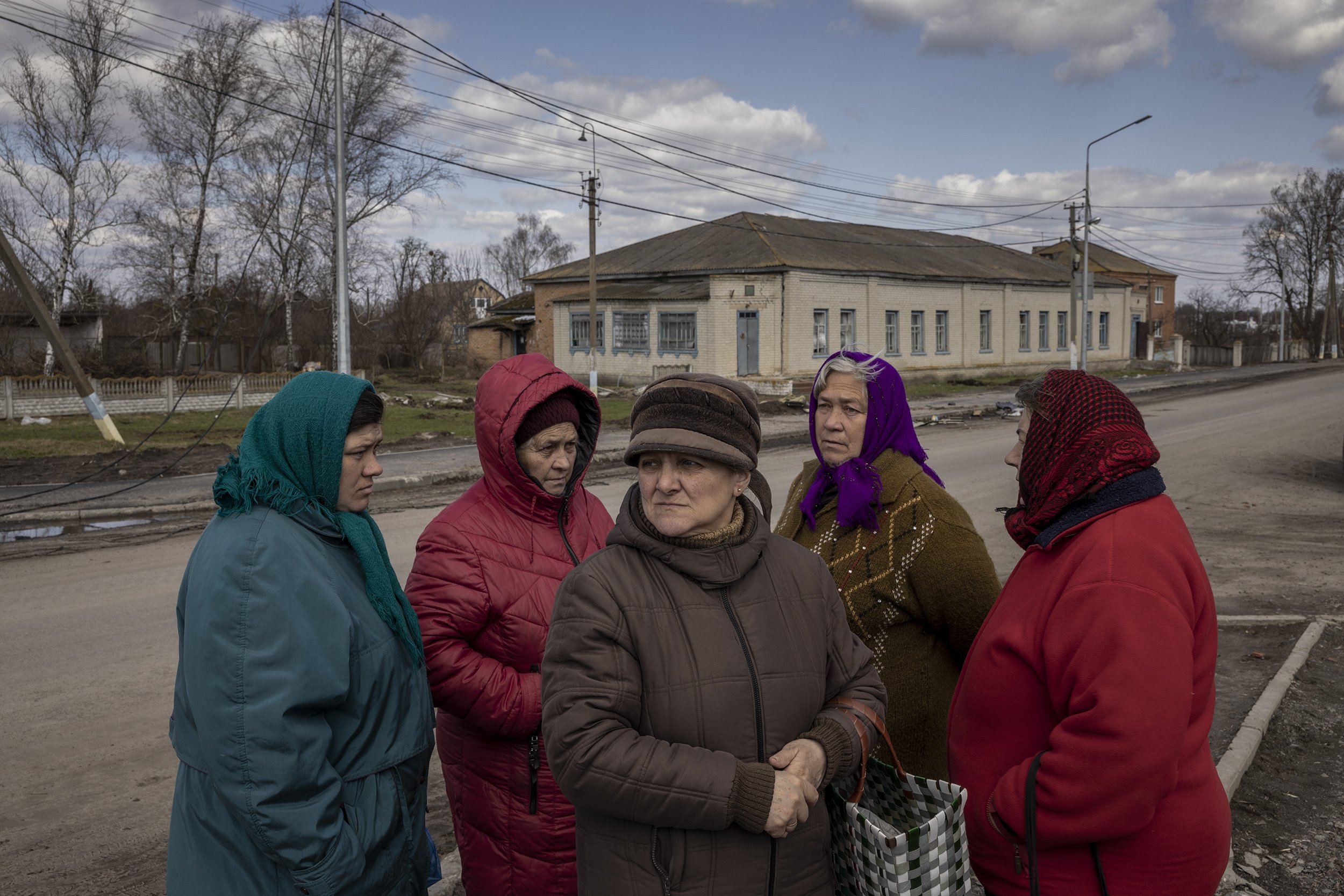  Several days after Russian forces had been driven from the area, a group of local women in the village of Nova Basan waited for fresh meat to be delivered for the first time in more than a month. April, 2022. 