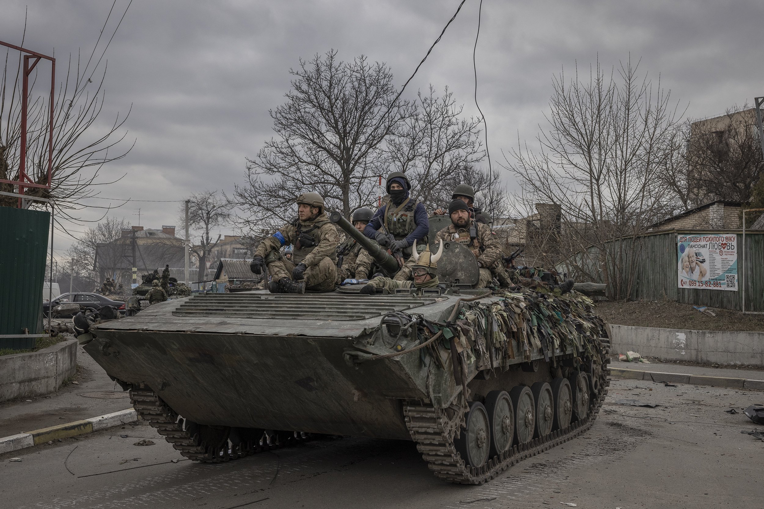  A column of Ukrainian armoured fighting vehicles and tanks moved through the destroyed streets of Bucha several days after Russian forces had withdrawn from the area. April, 2022. 