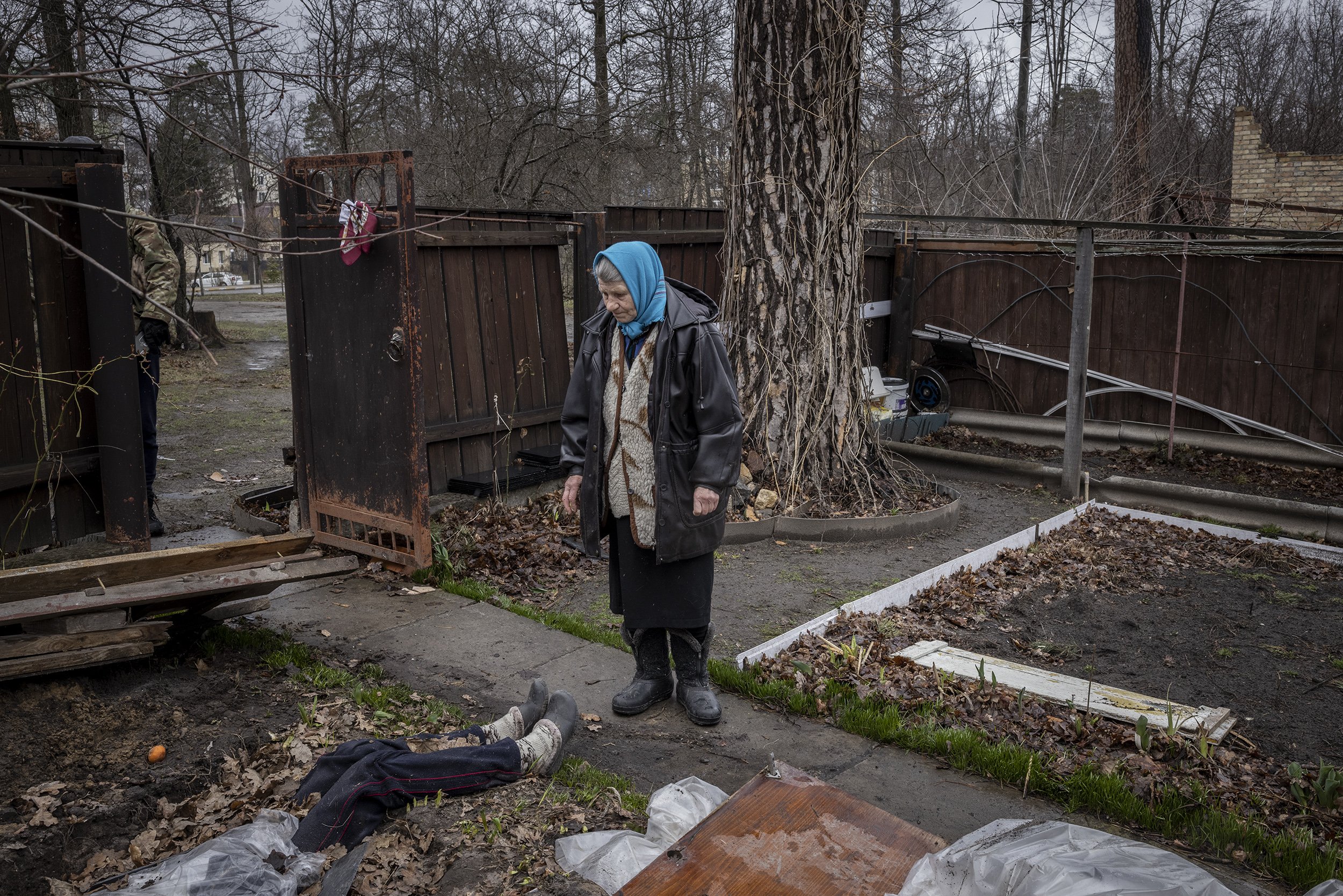  Antonina Pomazanko looked down at the half buried body of her daughter, Tetiana, which lay virtually where she had fallen after being shot by Russian forces when they entered Bucha on the 27th of February. Antonina had dug the shallow grave herself 