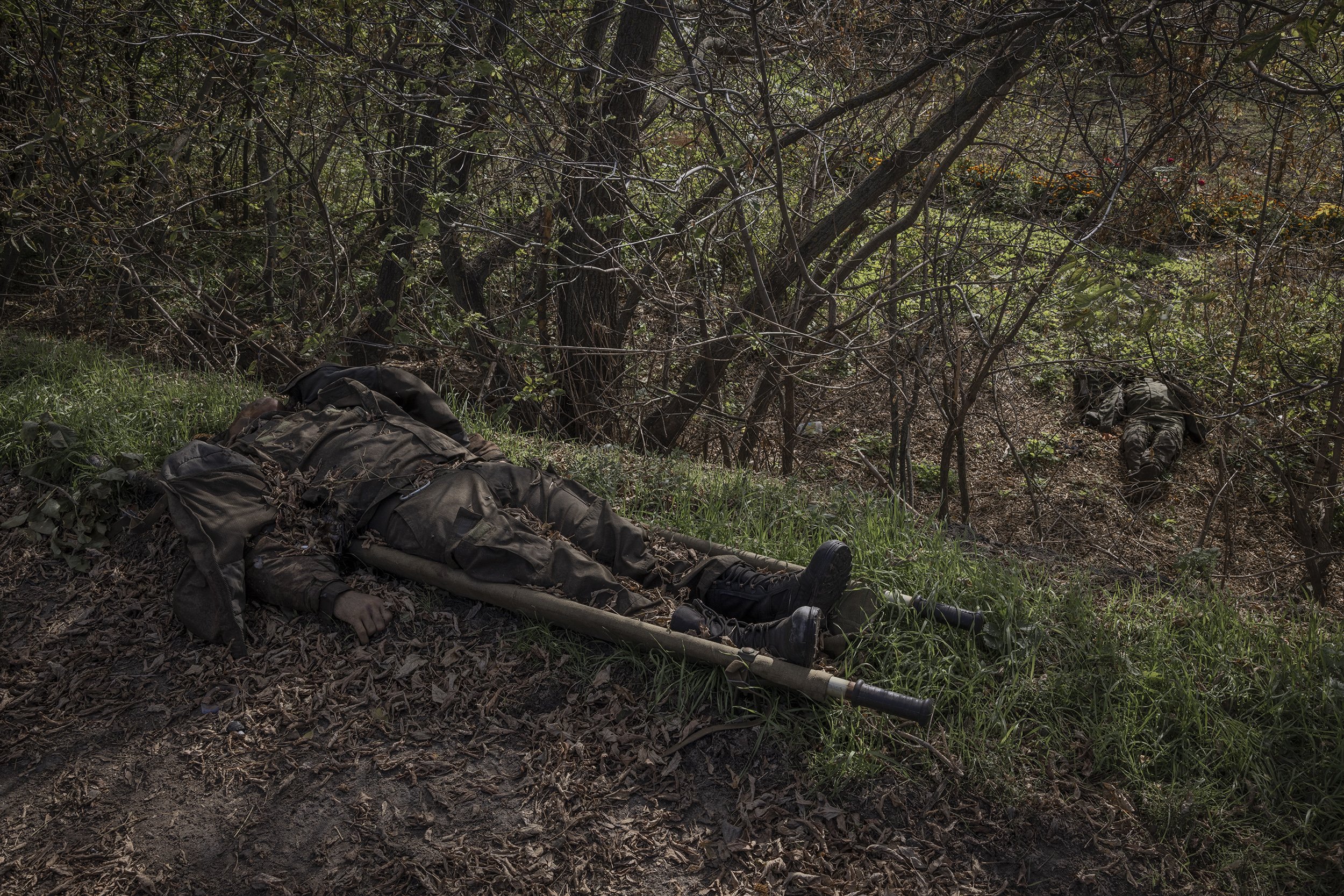  The bodies of two Russian soldiers lay near the side of the road on the eastern outskirts of Kupiansk. The area had been recaptured by Ukrainian forces several weeks earlier and fighting continued nearby. October, 2022. 