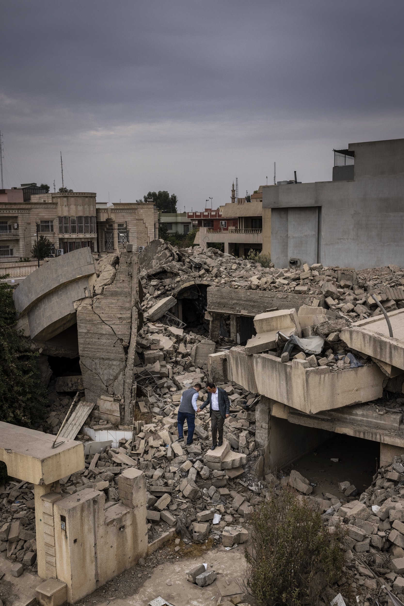  Mosul, Iraq - Rafi al-Iraqi and his son standing amid the rubble of their home in Mosul, Iraq. On Jan. 6, 2017, the target was a house assessed to be used exclusively as an ISIS “foreign fighter headquarters” and “artillery staging location.” But th