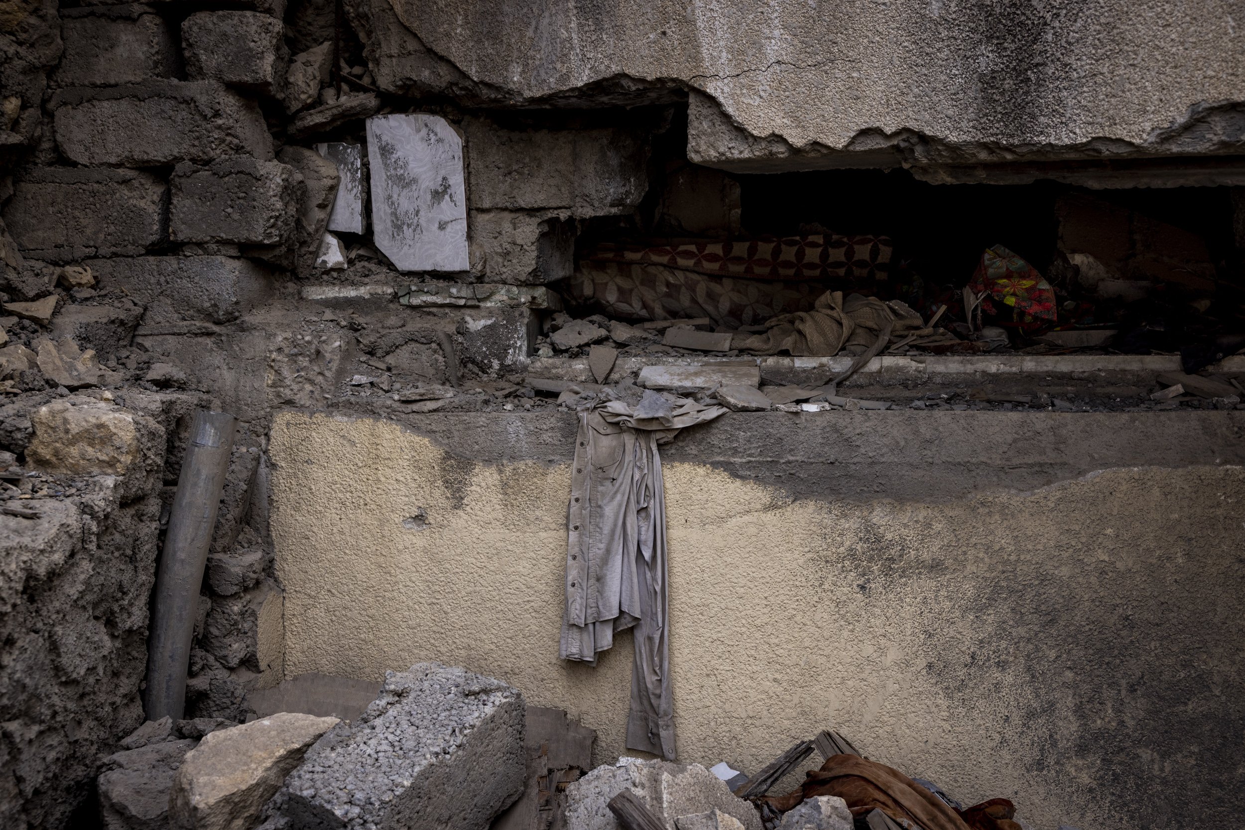 A shirt lay amid the rubble of the house where Rafi al-Iraqi and his family were living when it was hit by an airstrike.