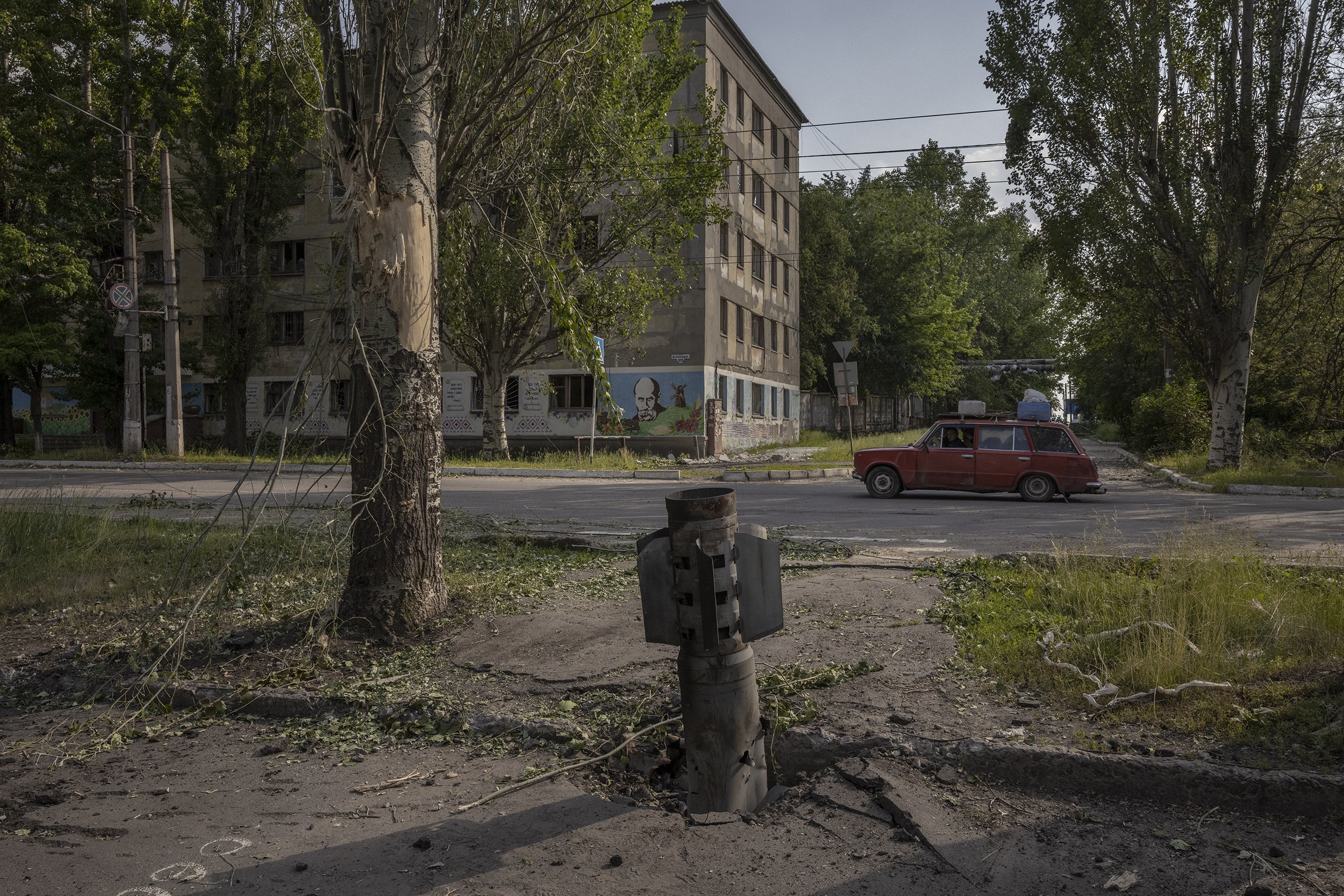  An unexploded Russian rocket protruded out of the pavement in the city of Lysychansk. June, 2022. 