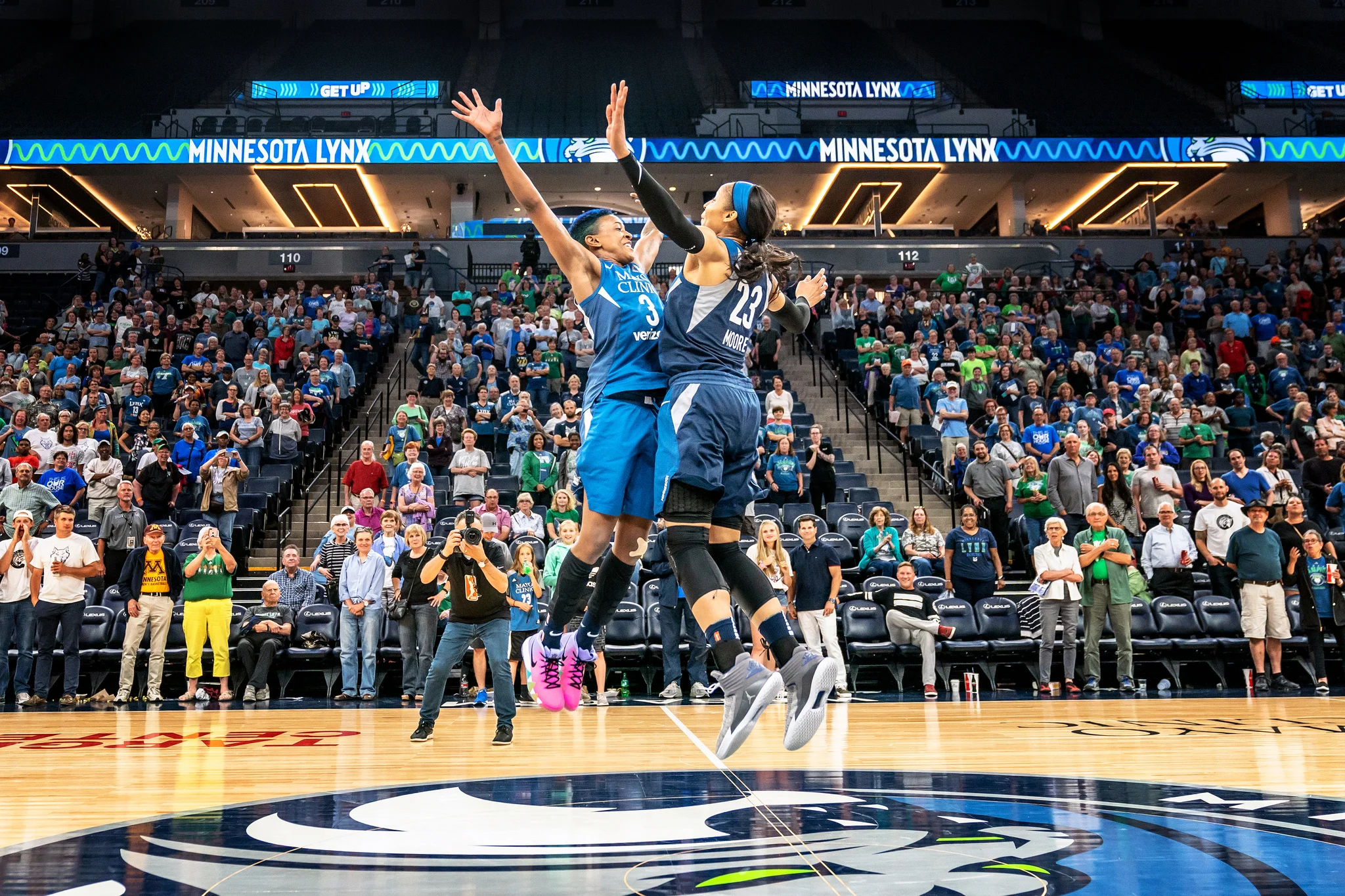 Danielle Robinson & Maya Moore celebrate a win against the Seattle Storm with a center court chest bump at at Target Center, Minneapolis.
