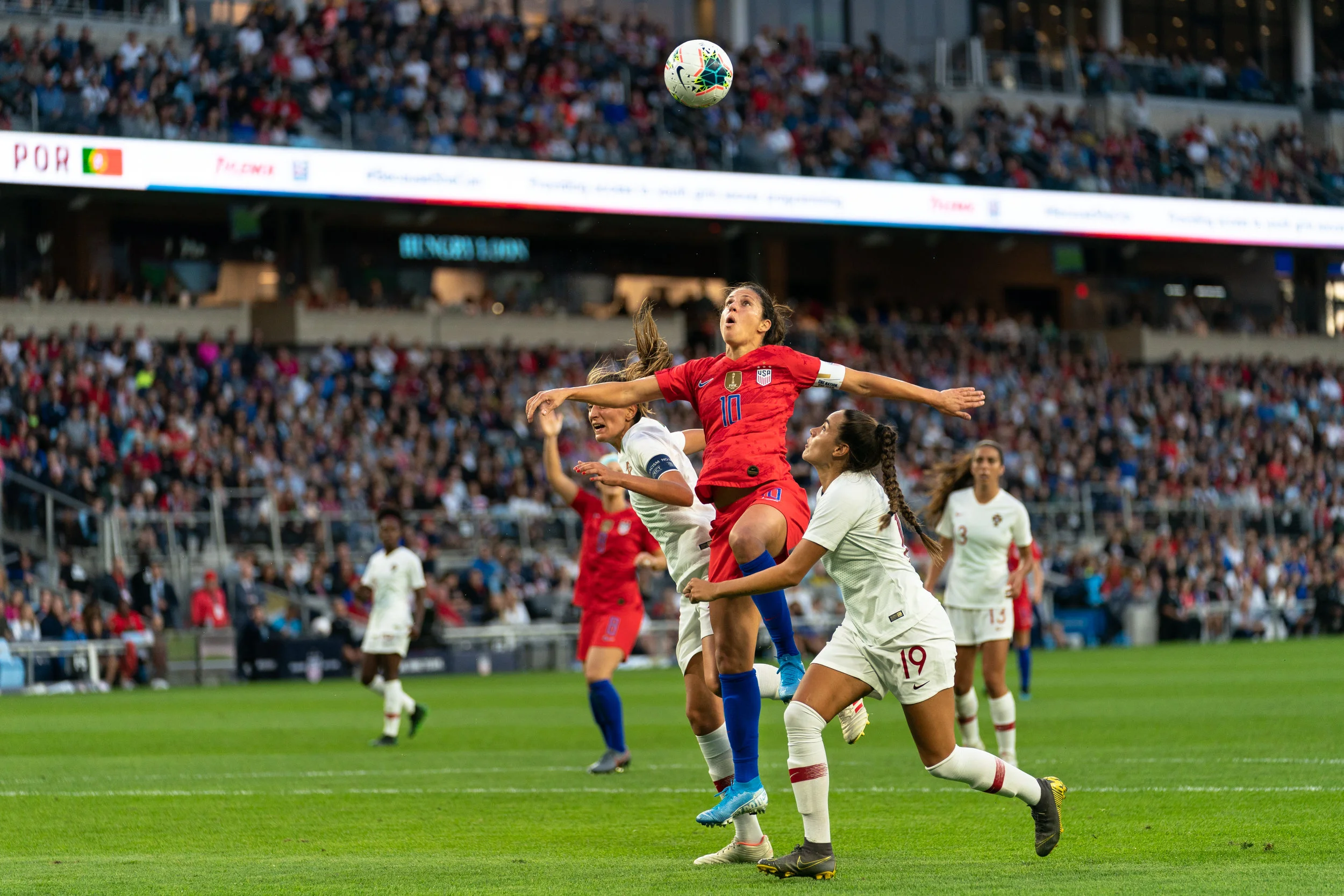Carli Lloyd heads a ball in the USWNT's Victory Tour game against Portugal