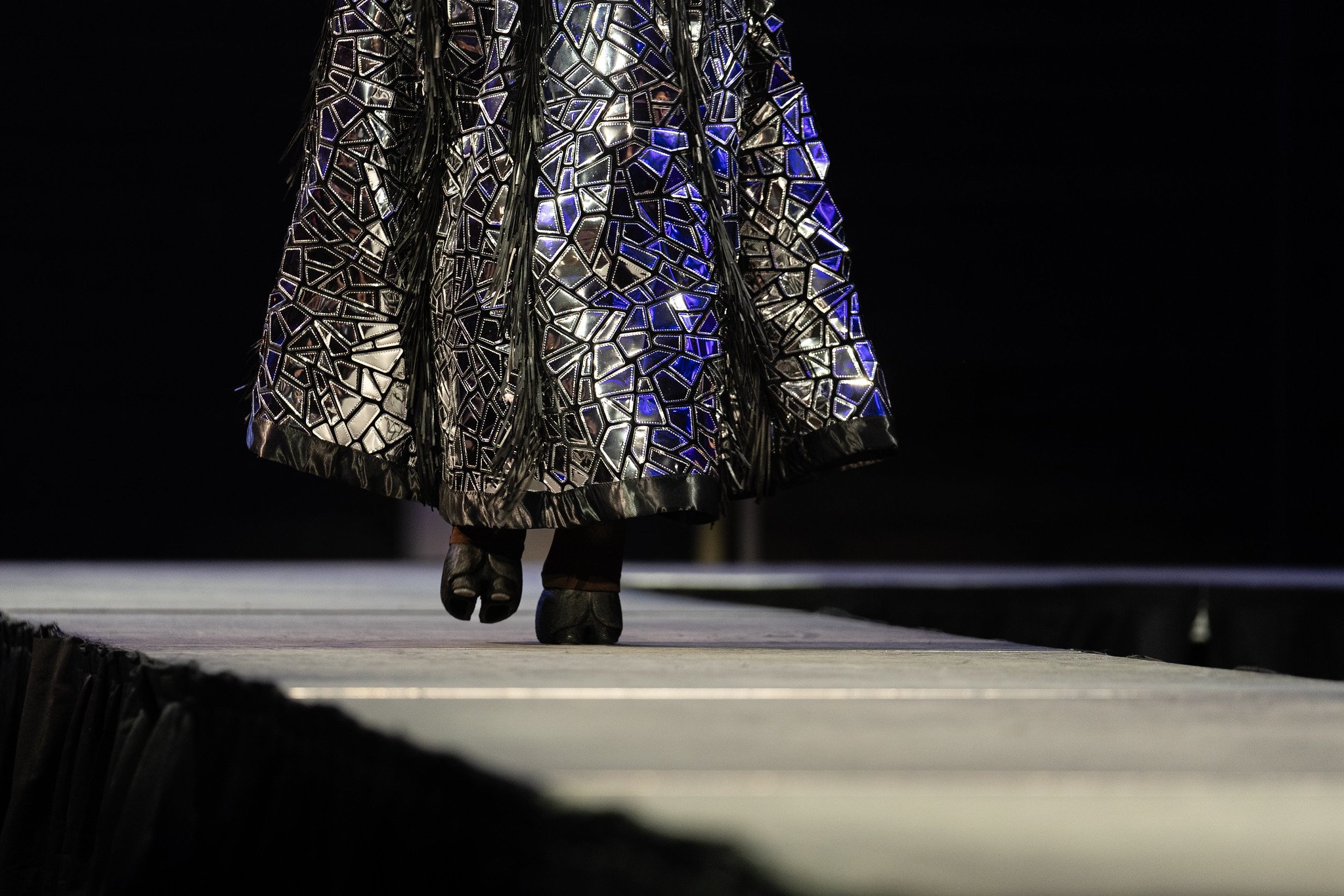 Closeup of a model's high heels that are shaped as horse hoofs on the runway at Native Nations Fashion Night in Minneapolis