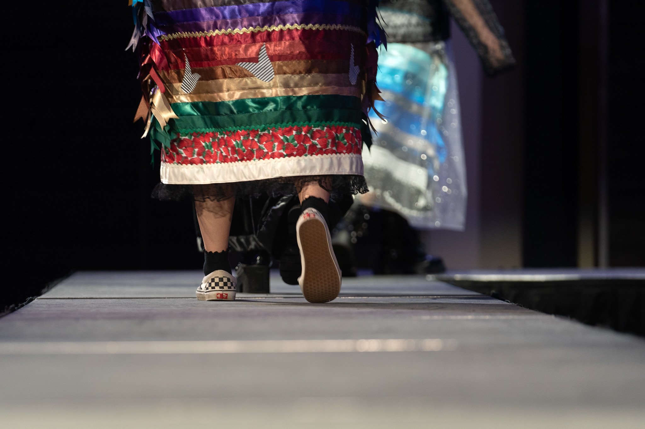 Closeup of a model wearing designs by Rebecca Mousseau on the runway at Native Nations Fashion Night in Minneapolis