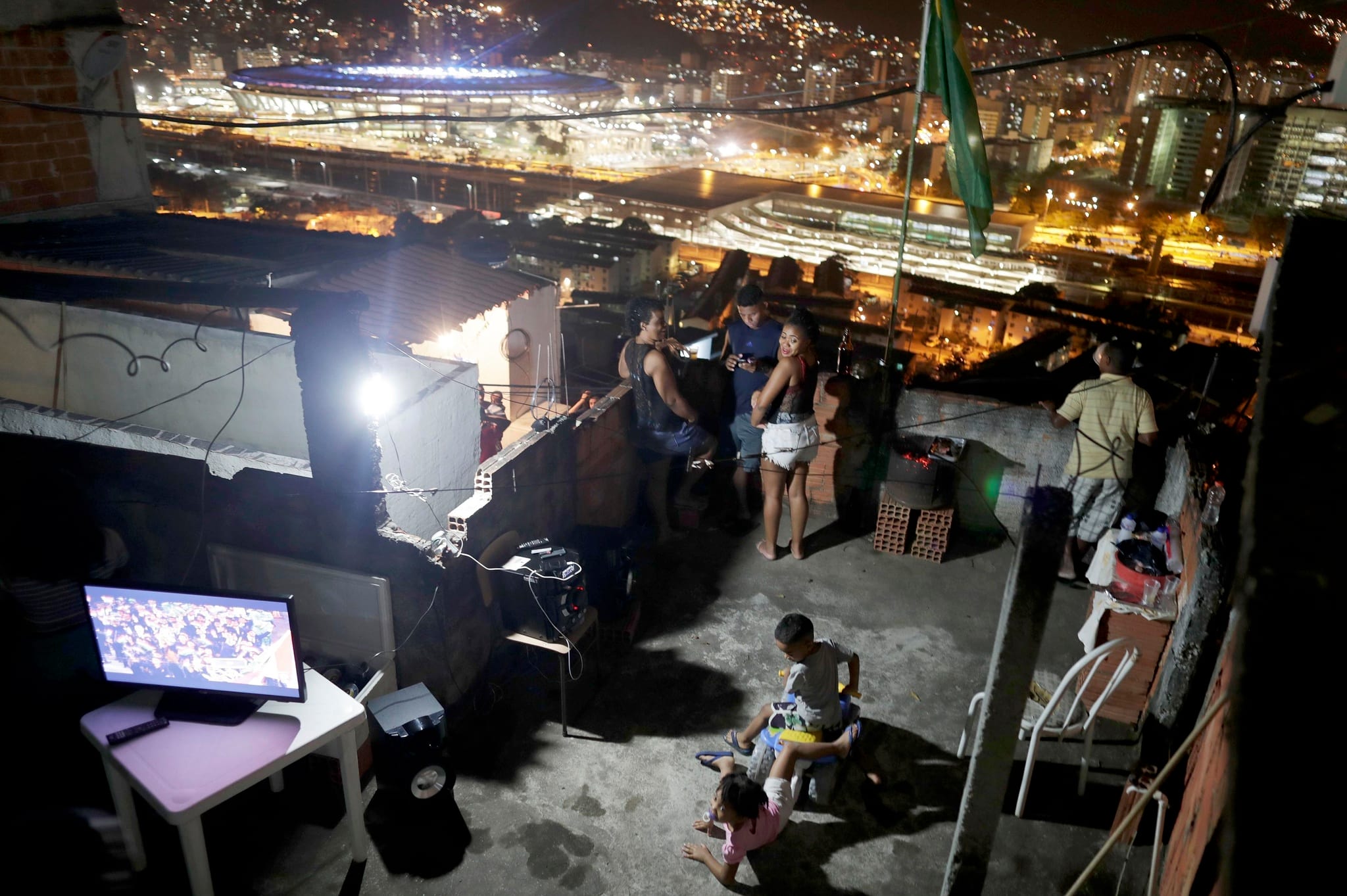 Mangueira residents watch the Olympics Opening Ceremony, Aug 2016. Photo by Ricardo Moraes, Reuters.